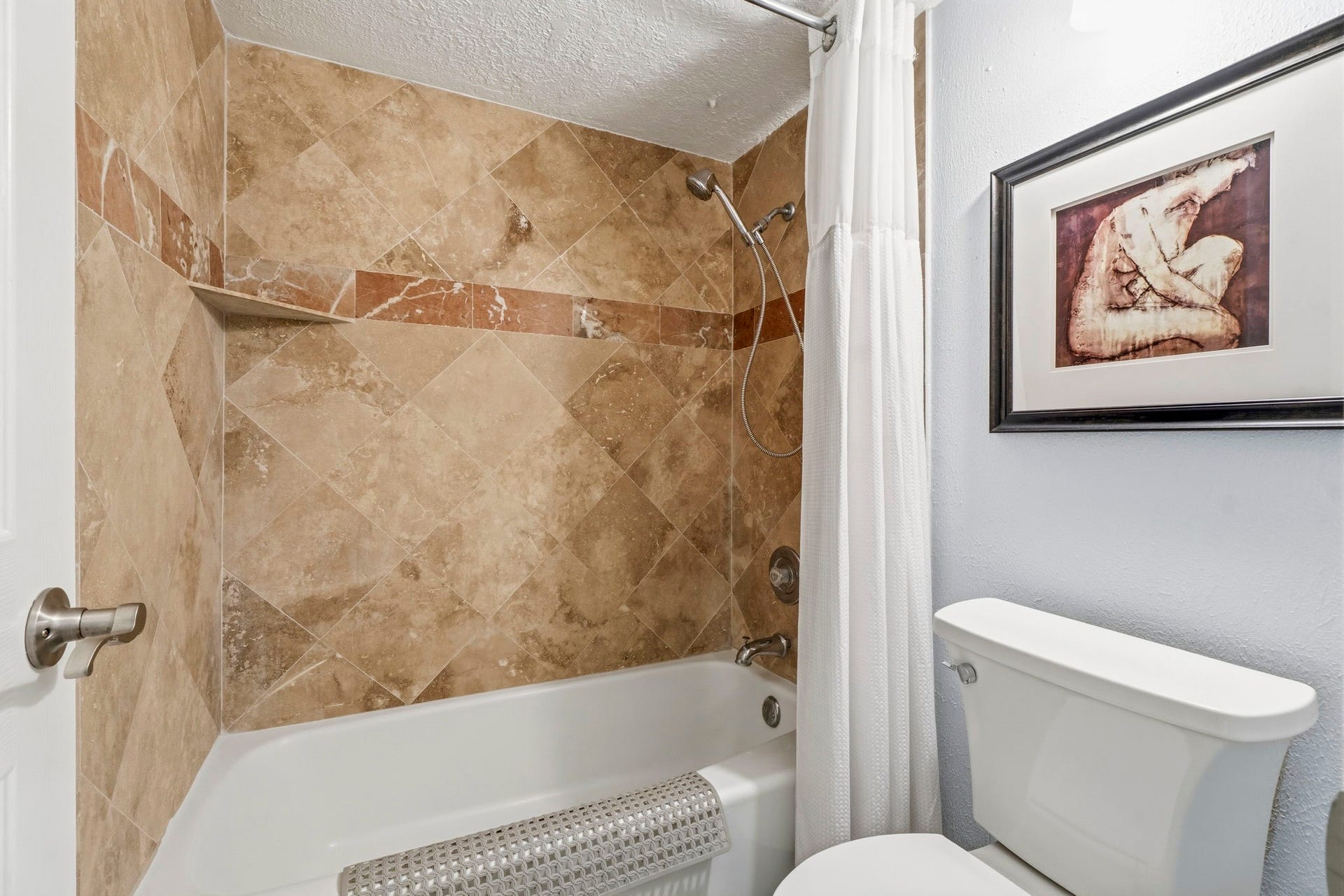 Custom Tile Bath Beautiful tile work and updated fixtures create a stylish and functional guest bathroom.