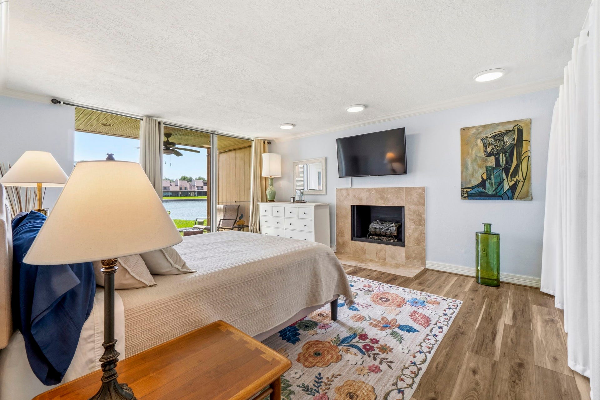 Wake Up to Lake Conroe Large primary suite with direct patio access, abundant natural light, and stunning waterfront scenery.