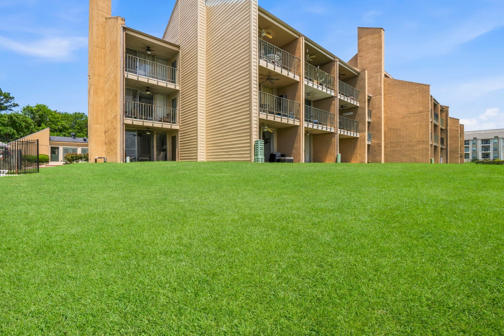Lush green lawns stretch to the waters edge, creating a picturesque setting for outdoor enjoyment and unforgettable lake views.