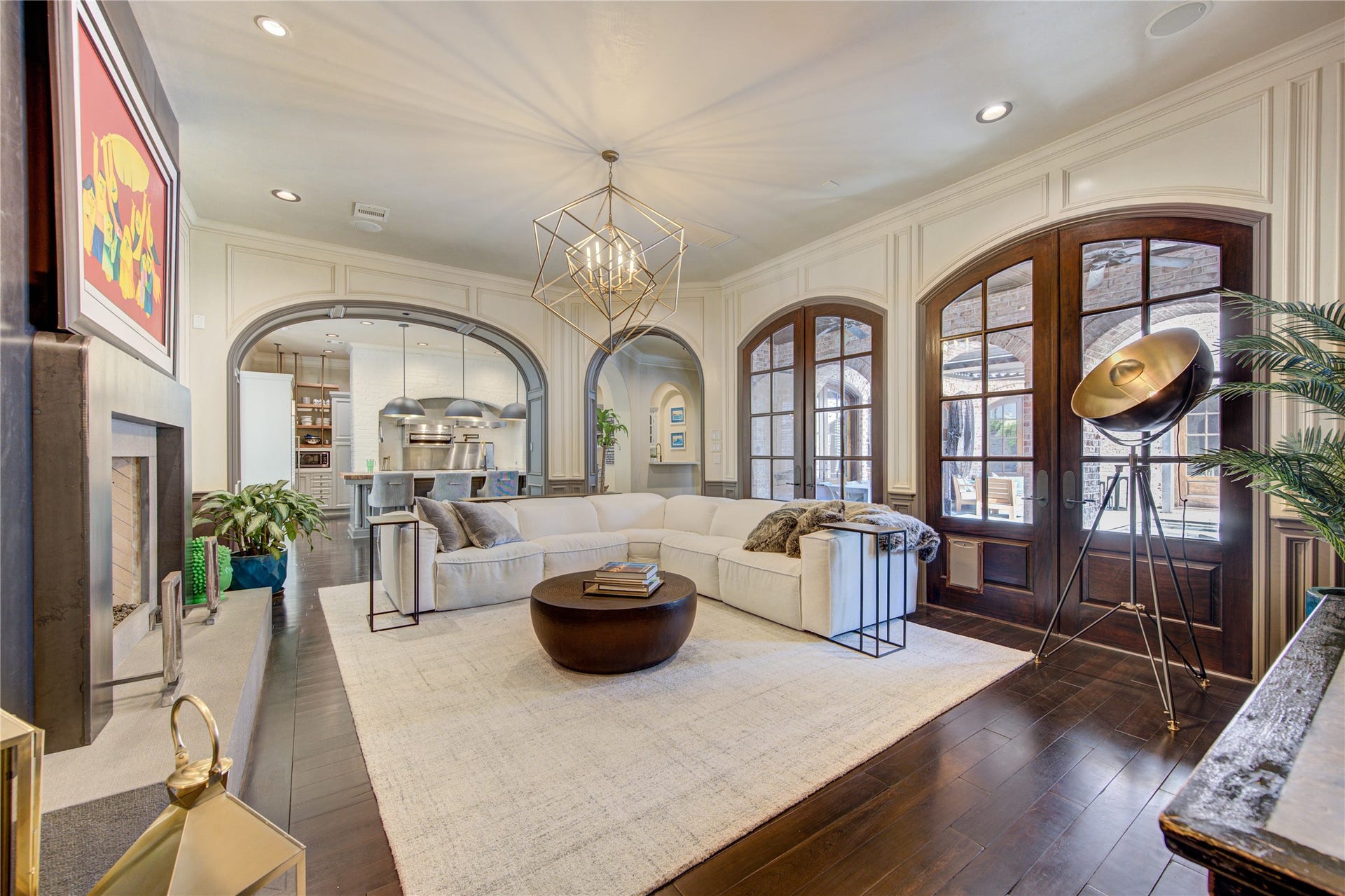 5110 W Oak Mews, Houston, TX 77056 The elegant living room is a masterpiece of timeless design, where dramatic floor-to-ceiling windows crafted to resemble French doors create a seamless connection to the private courtyard. Bathed in natural light, this sophisticated gathering space showcases refined architectural details while framing breathtaking views of the sparkling pool, inviting indoor-outdoor living and effortless entertaining in a tranquil, resort-inspired setting.
