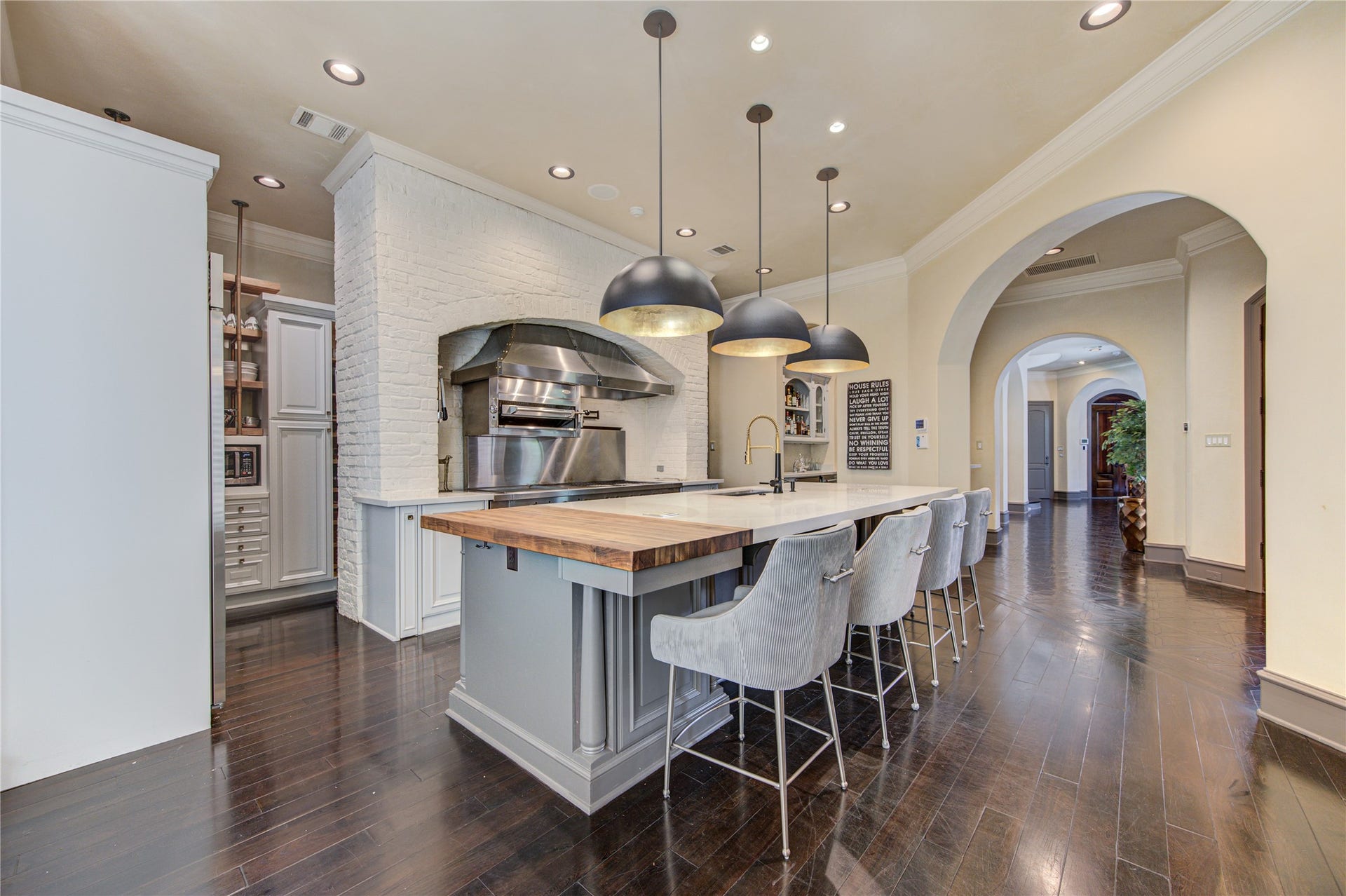 5110 W Oak Mews, Houston, TX 77056 The thoughtfully designed scullery adds exceptional functionality with abundant custom storage, a built-in microwave, and dedicated countertop space for small appliances, keeping everyday essentials organized and out of sight. Perfect for entertaining, this hidden prep area allows the main kitchen to remain beautifully uncluttered while providing effortless convenience for daily living.