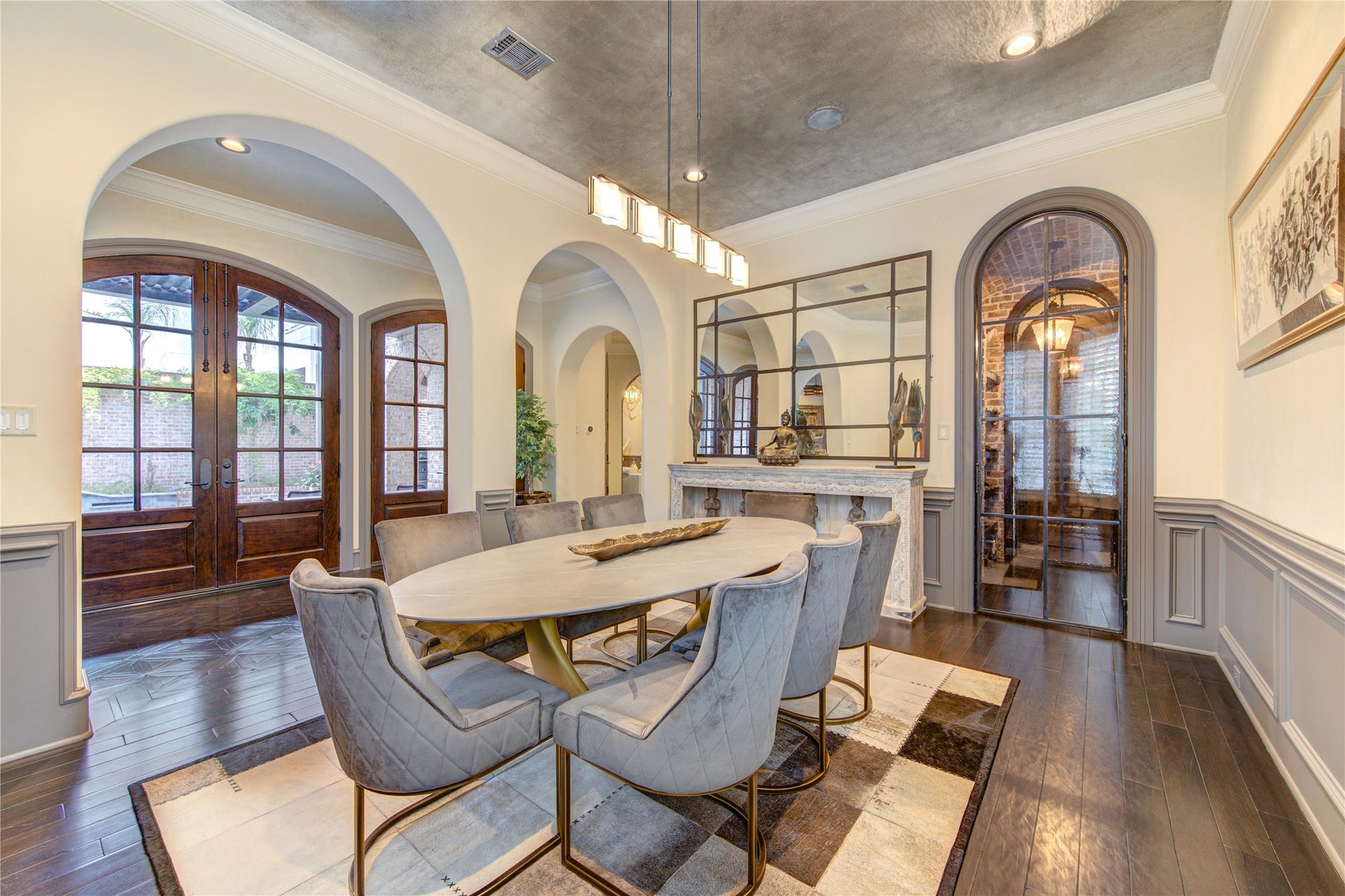 5110 W Oak Mews, Houston, TX 77056 Gorgeous wood doors provide a seamless transition to the resort like outdoor space from the formal dining room. Step through the door into the wine vault that will make entertaining a breeze.