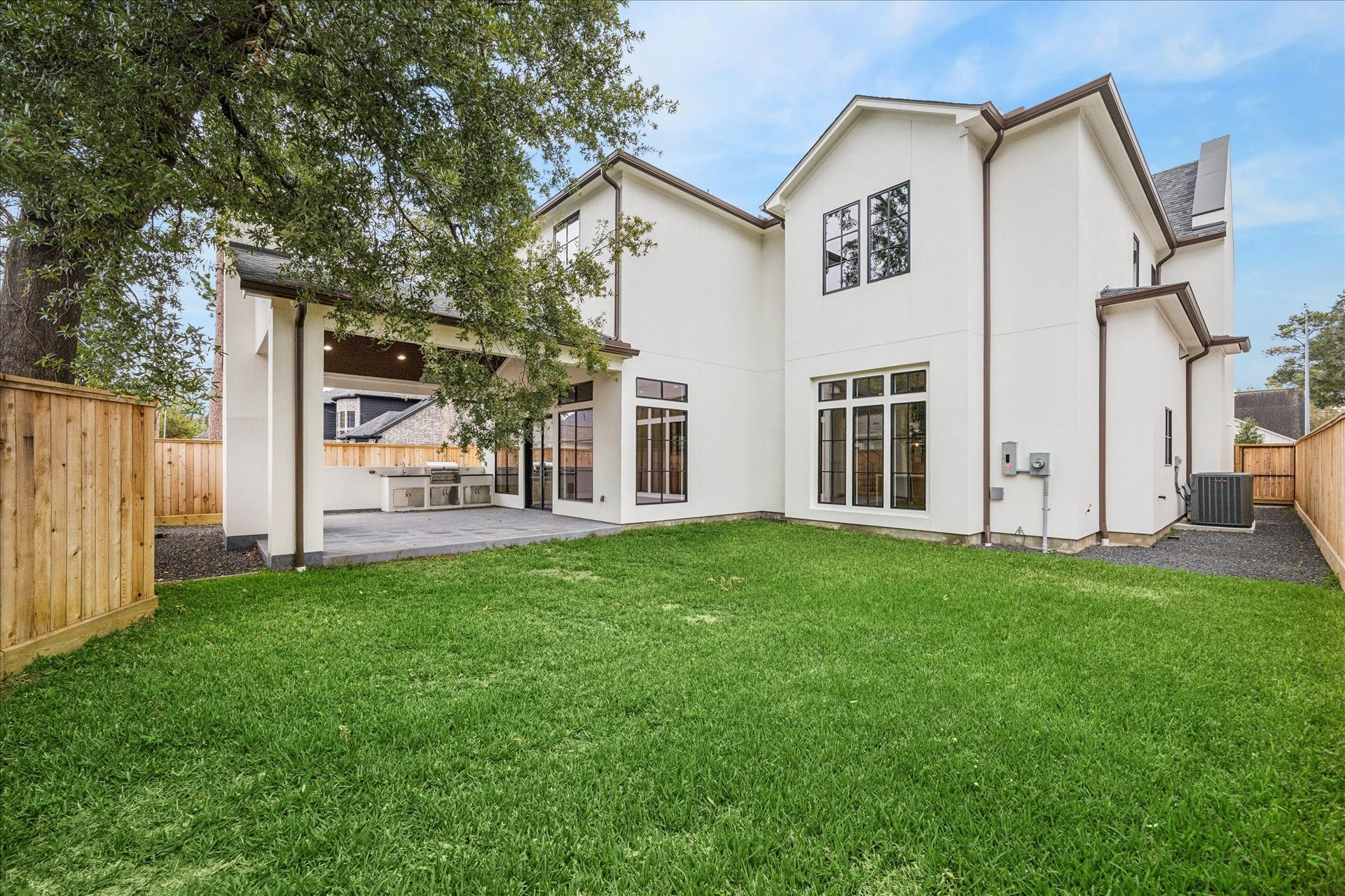 A wide lawn pairs with the deep covered patio, offering space for future pool design, gardening, or play. Rear elevation windows echo the homes clean modern symmetry and fill interiors with daylight. *Previous Project*