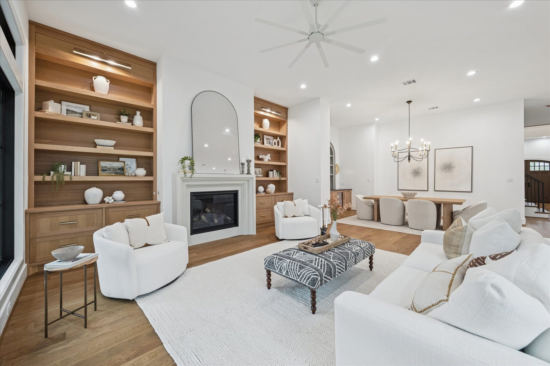 Soft textures and layered neutrals define this inviting gathering space. Generous seating options and unobstructed sightlines reinforce the homes indooroutdoor rhythm, supported by the quiet comfort of Trane HVAC and spray foam insulation. *Previous Project*