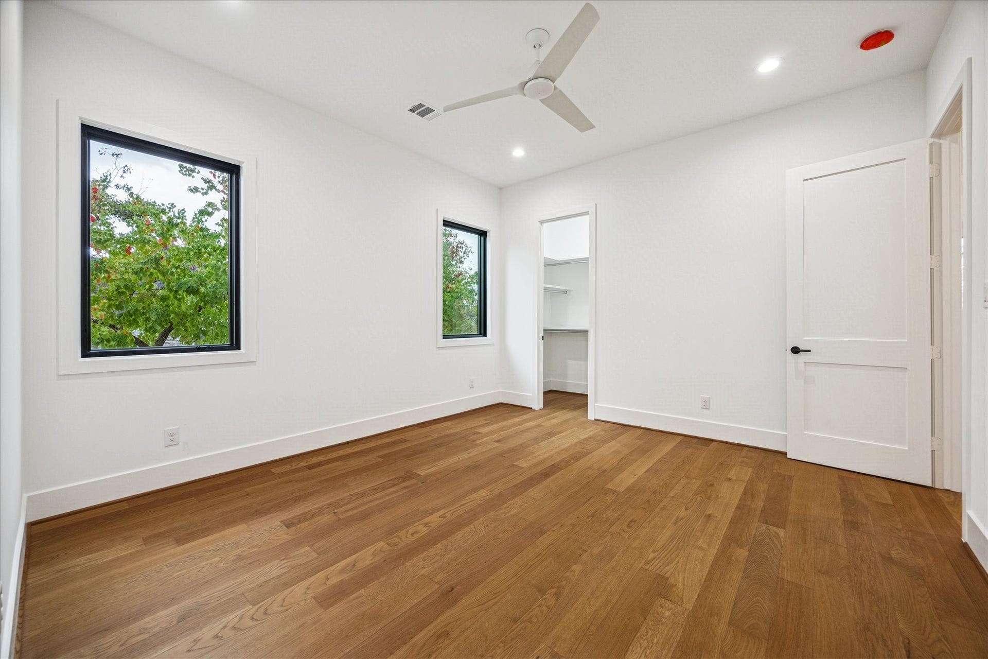 Large Pella windows frame leafy views while generous floor space supports flexible layouts. The en-suite bath and ample closet storage enhance everyday comfort. *Previous Project*