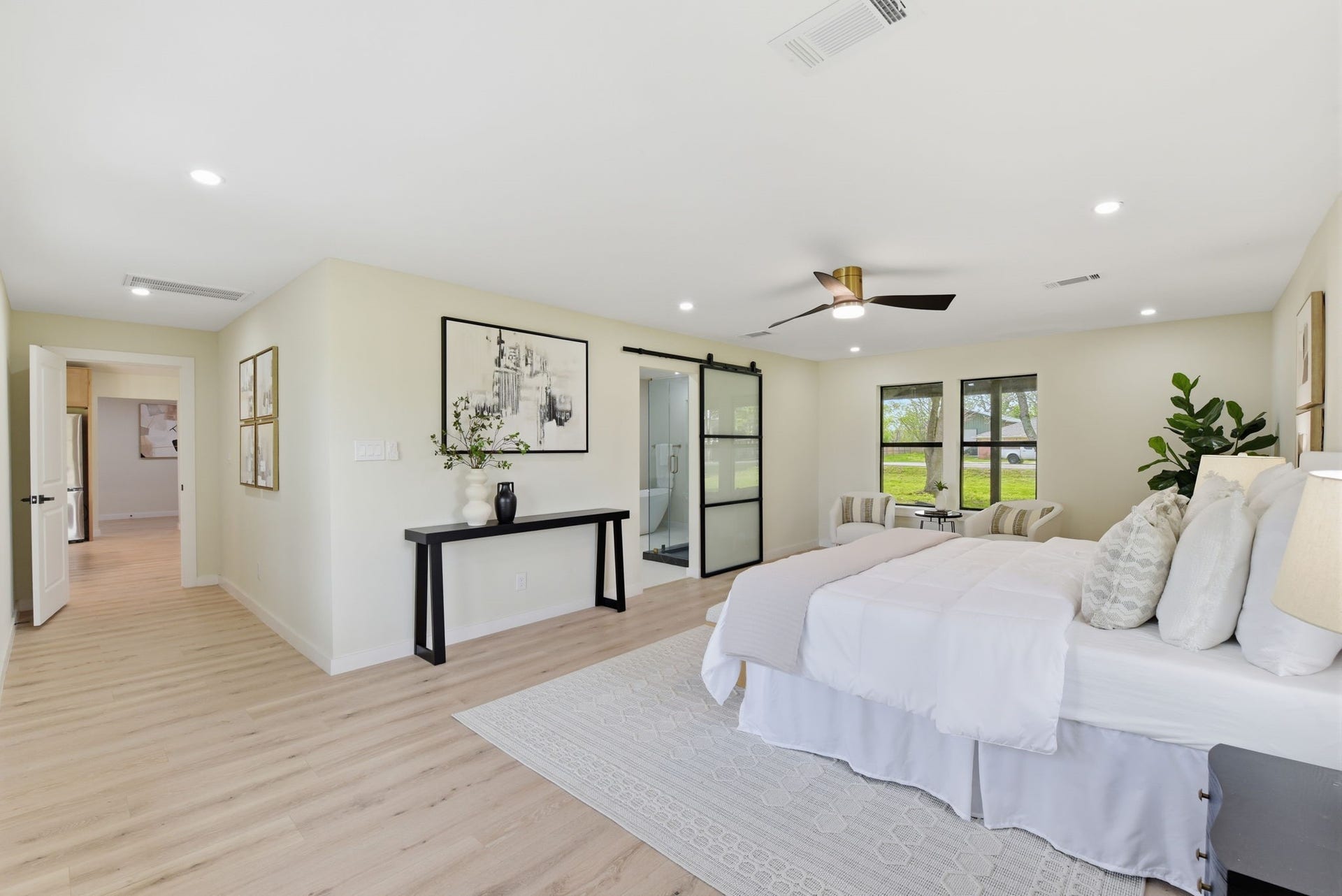 1011 Sycamore Road, Richmond, TX 77469 Primary suite with a view of the barn door to lead to the designer grade primary bathroom