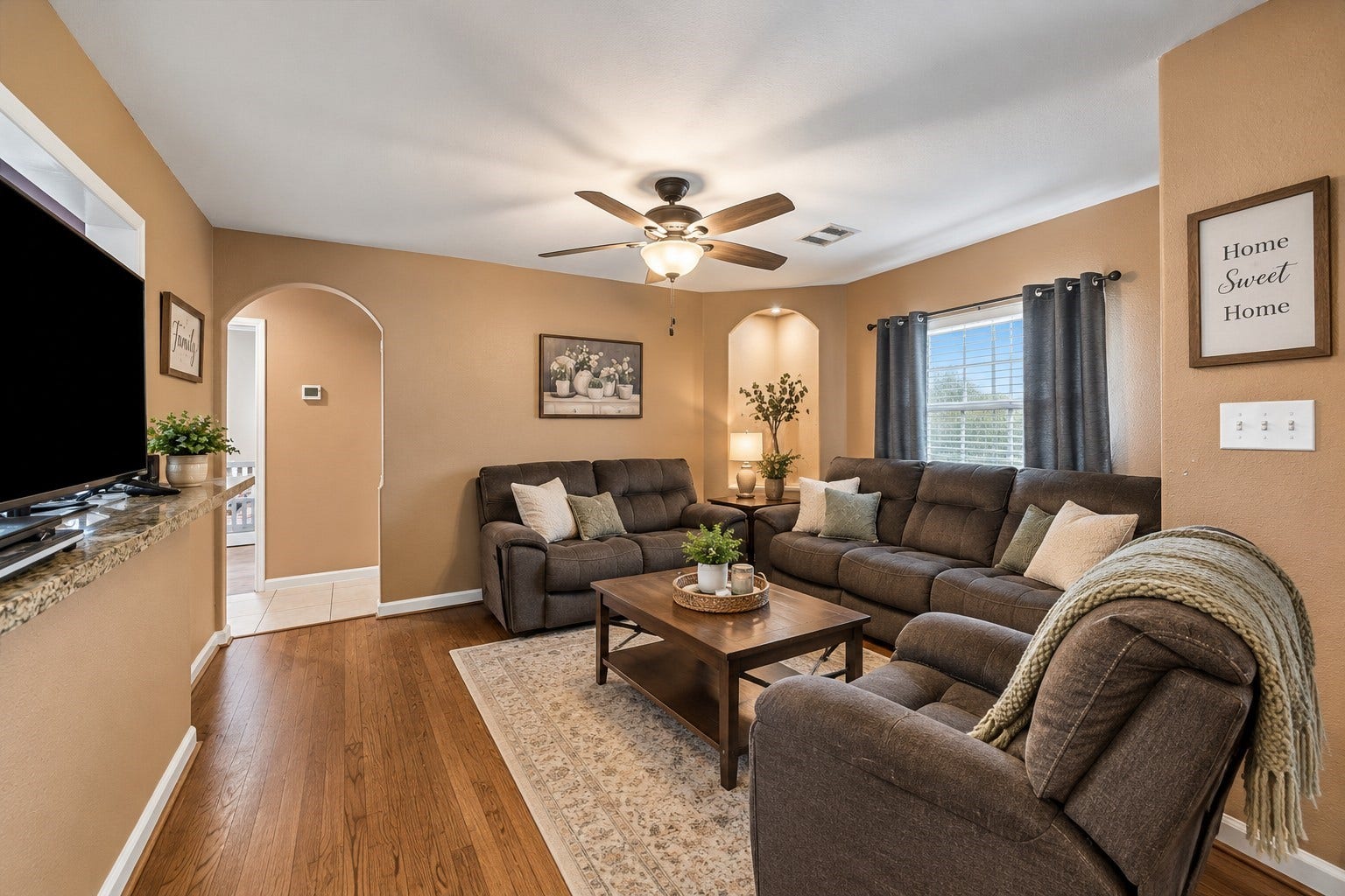 Natural light pours through the front windows of this comfortable living space, perfect for movie nights or relaxing after a long day.