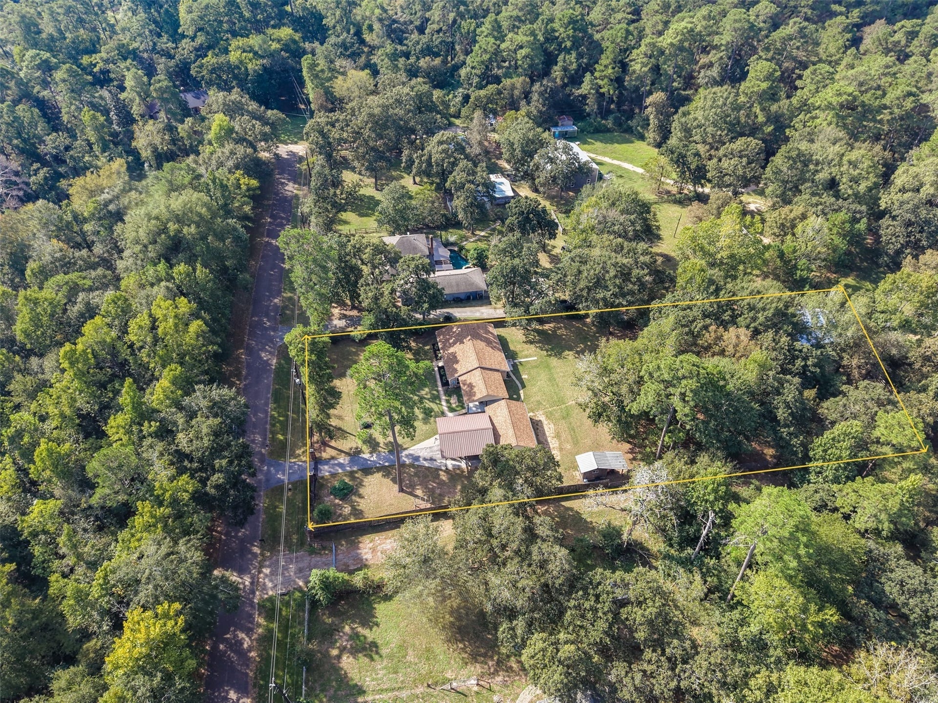 This gives you a little more perspective of how this property is laid out and positioned. You have fantastic views of the heavily wooded area across the street and on the front sides of the property you enjoy the privacy fencing as the back fences offer a more open feel as it is three rail fencing. The front is fenced with beautiful wrought iron fencing and a wrought iron gate. The property is approximately 132' wide, and 340' feet deep.