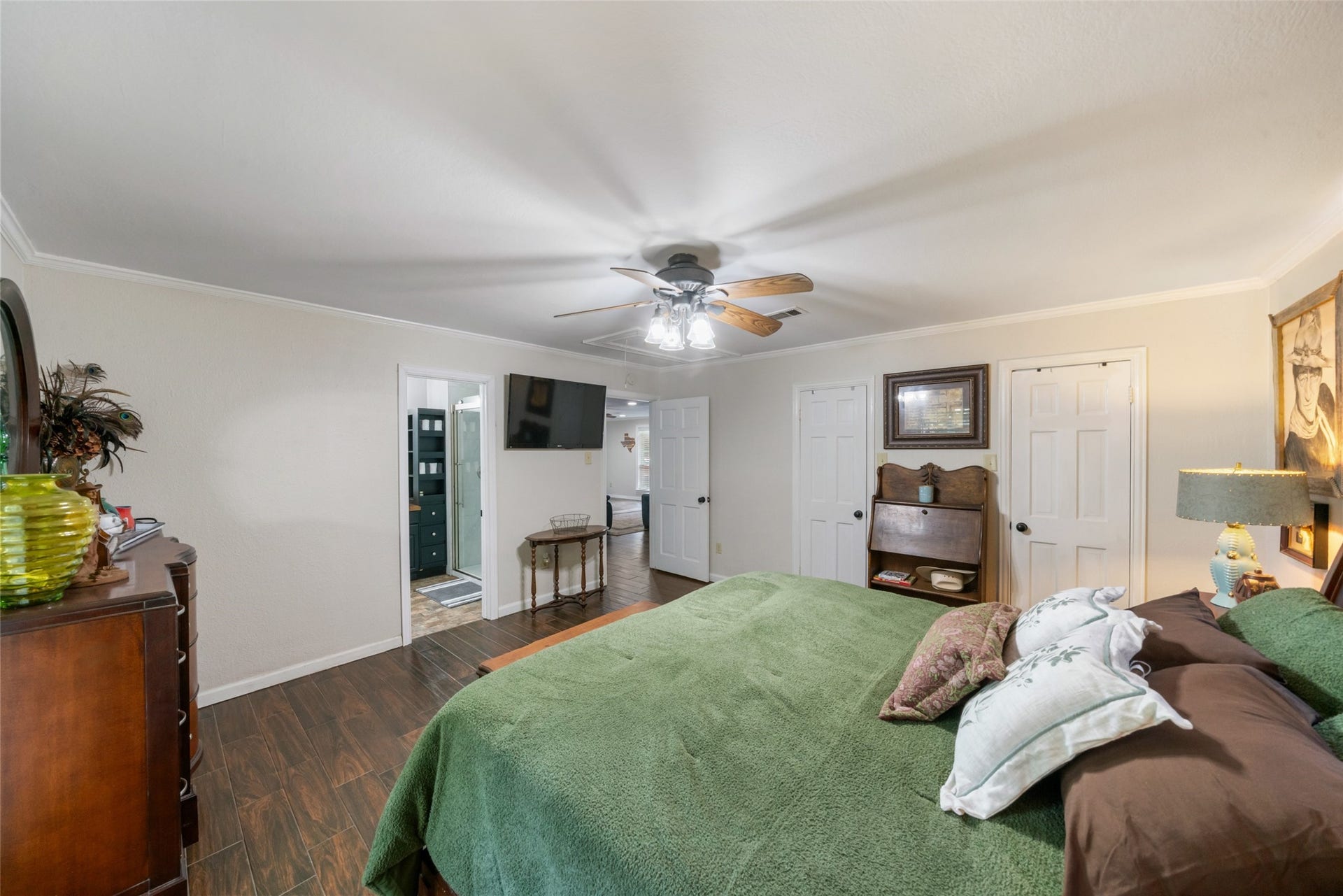 Another inviting view of the primary suite showcases the easy access to the full ensuite, along with a glimpse into the living area just beyond. This layout keeps the space feeling open and connected while still offering the privacy and comfort expected in a primary retreat.