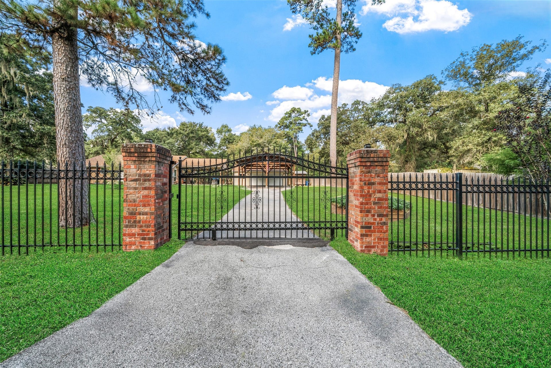 Gorgeous wrought iron gate that can be rolled shut if you need a bit more privacy or if you would like to secure it should you be away from home for a period of time. Thank you again for taking time to view this home and all that it has to offer. We hope to see you soon for your private tour. Note: Front and backyard grass, has been enhanced)