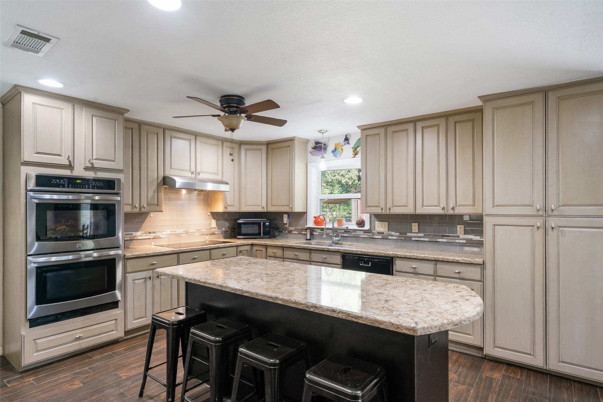 This gorgeous island offers additional seating and serves as a true centerpiece for the kitchen. The large cabinets to the right are wonderfully versatile perfect for extra pantry storage or anything else you need to tuck away. Its a smart, functional setup that adds both beauty and practicality.