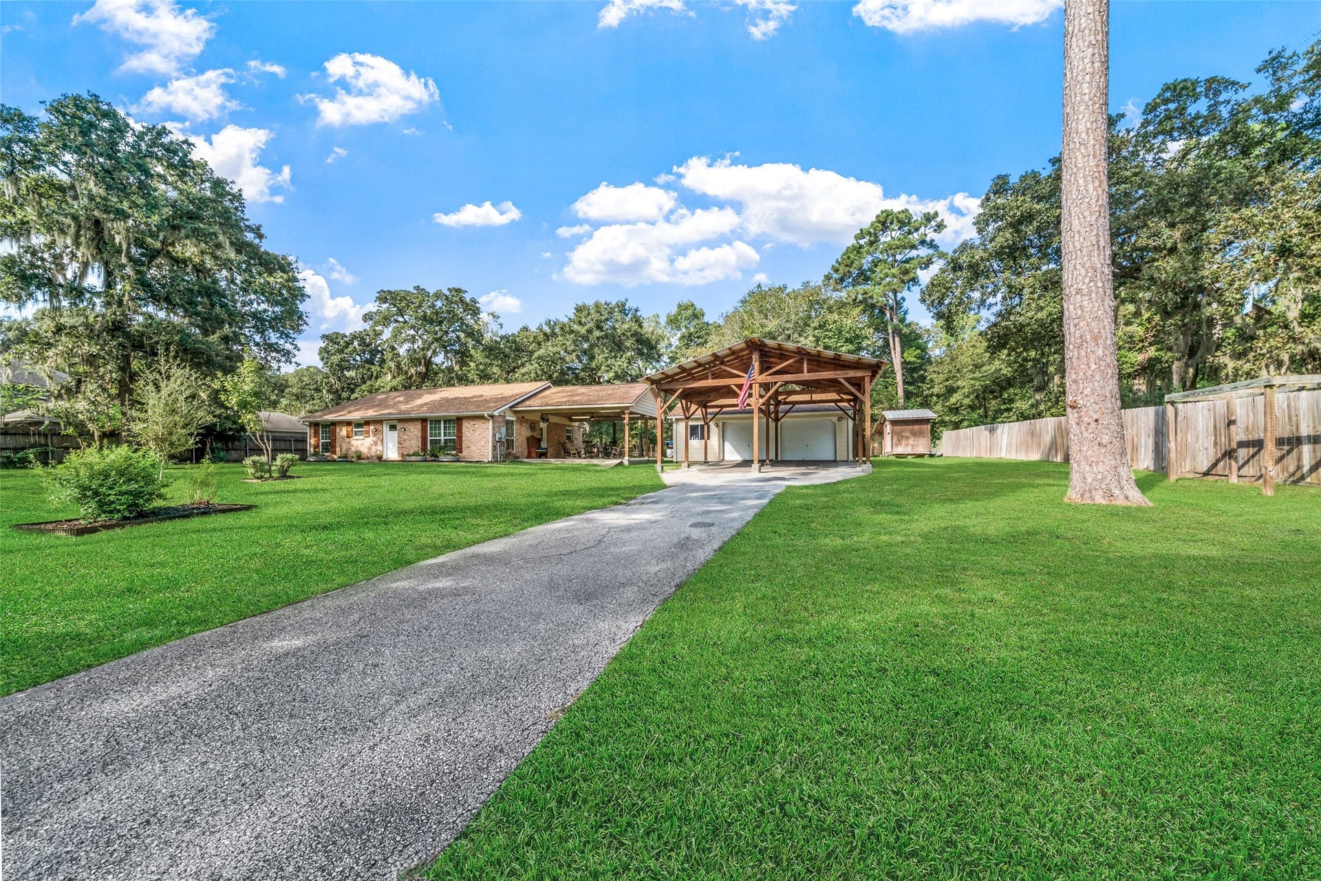 This property offers expansive parking that makes hosting gatherings effortless, and the covered patio delivers phenomenal breezes thanks to its open views to both the front and back of the property. The gorgeous oak tree draped in moss is spectacular and becomes a focal point you can admire from the patio. Theres so much space to roam and relax. Whether youre grabbing a beverage and enjoying an afternoon snack on the patio, or firing up the grill for a barbecue, this outdoor setup is truly phenomenal.