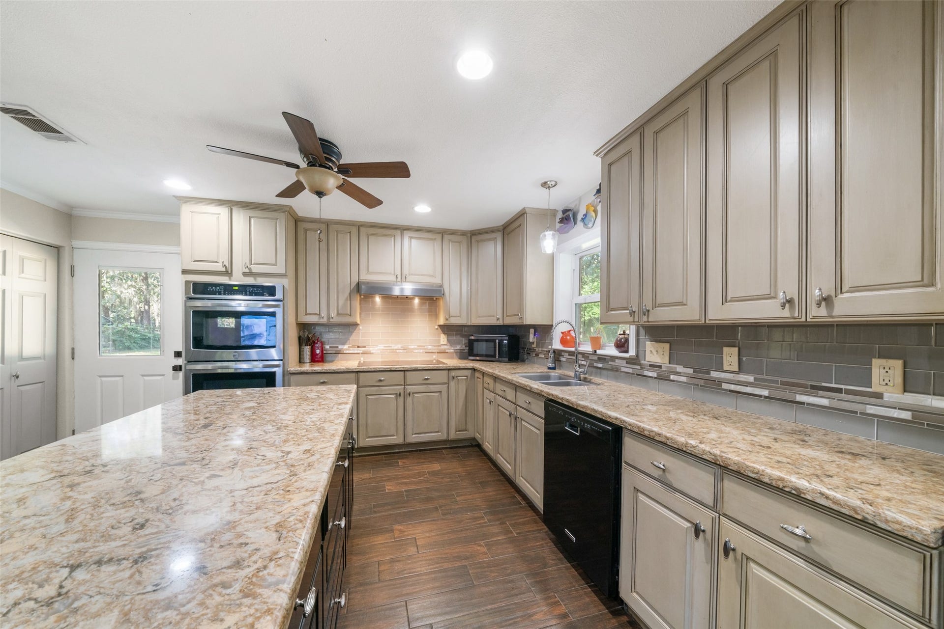 This kitchen delivers all the counter space and cabinetry you could ever want, truly an abundance of both, making it ready for the chef of the house. The layout is fantastic, offering easy flow and plenty of room to prep, cook, and gather. As a bonus, youll enjoy an awesome view of the backyard, along with quick, convenient access to step outside for a breath of fresh air. Its a beautifully designed space that checks all the boxes.