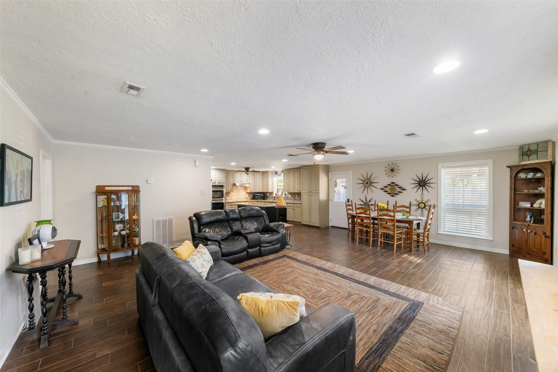 This beauty is all about connection, comfort, and effortless flow. No matter where youre seated in this home, you truly have one of the best views in the house, the open layout keeps everyone together, whether youre relaxing in the living area, enjoying a meal in the dining space, or moving through the kitchen. Light neutral paint, elegant crown molding, framed windows with blinds, and durable tile flooring all work together to create a bright, cohesive, and inviting atmosphere.