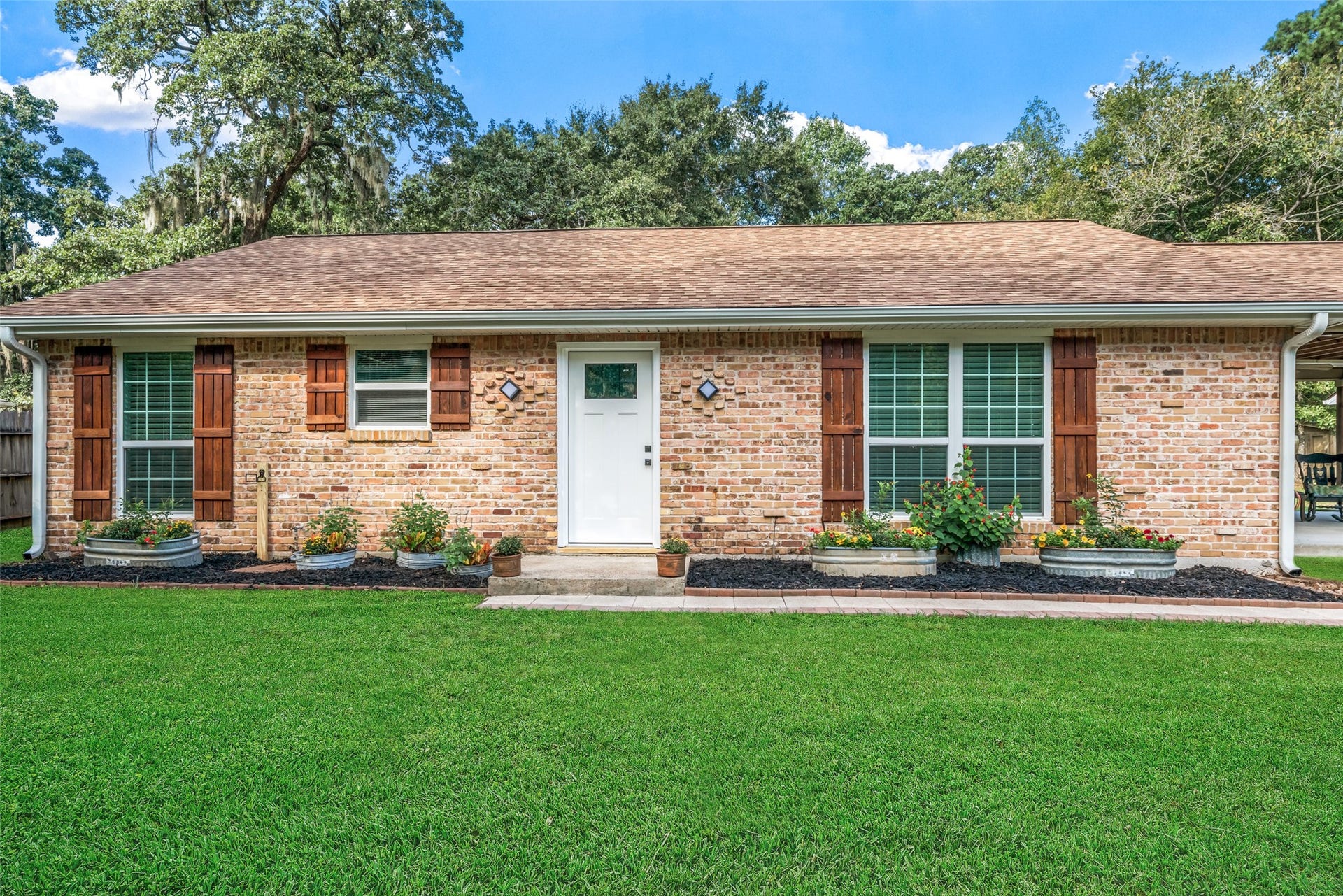Quaint and beautiful both inside and out! No expense spared as updates include: New exterior doors and lighting (2026), updated windows (2015), roof (2025), radiant barrier in attic (2017), HVAC (2026), covered patio (2015), carport (2021), barn (2024), Kitchen remodel over $50K (2015), primary and secondary bath remodel (2025-26), tile flooring throughout (2015), electrical panel (2015), generator plug (2016), storage sheds (2016), back fencing w/doggie wire (2017&2020) and more!
