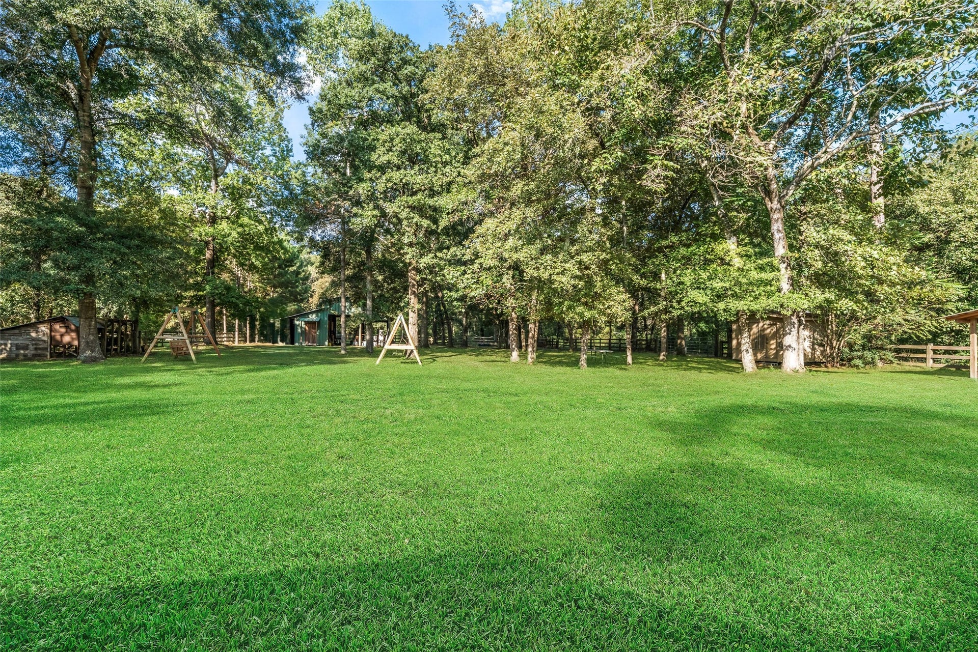 This gorgeous backyard showcases beautiful hardwoods providing shady spots to relax and sunny areas perfect for planting a garden. A versatile barn sits toward the back of the property, ready to accommodate a variety of needs. The entire backyard is enclosed with three-rail fencing and doggie wire for added security for your fur babies. Whether you envision a peaceful retreat, a garden oasis, or a cozy fire pit surrounded by chairs, theres plenty of room to create your own outdoor haven!