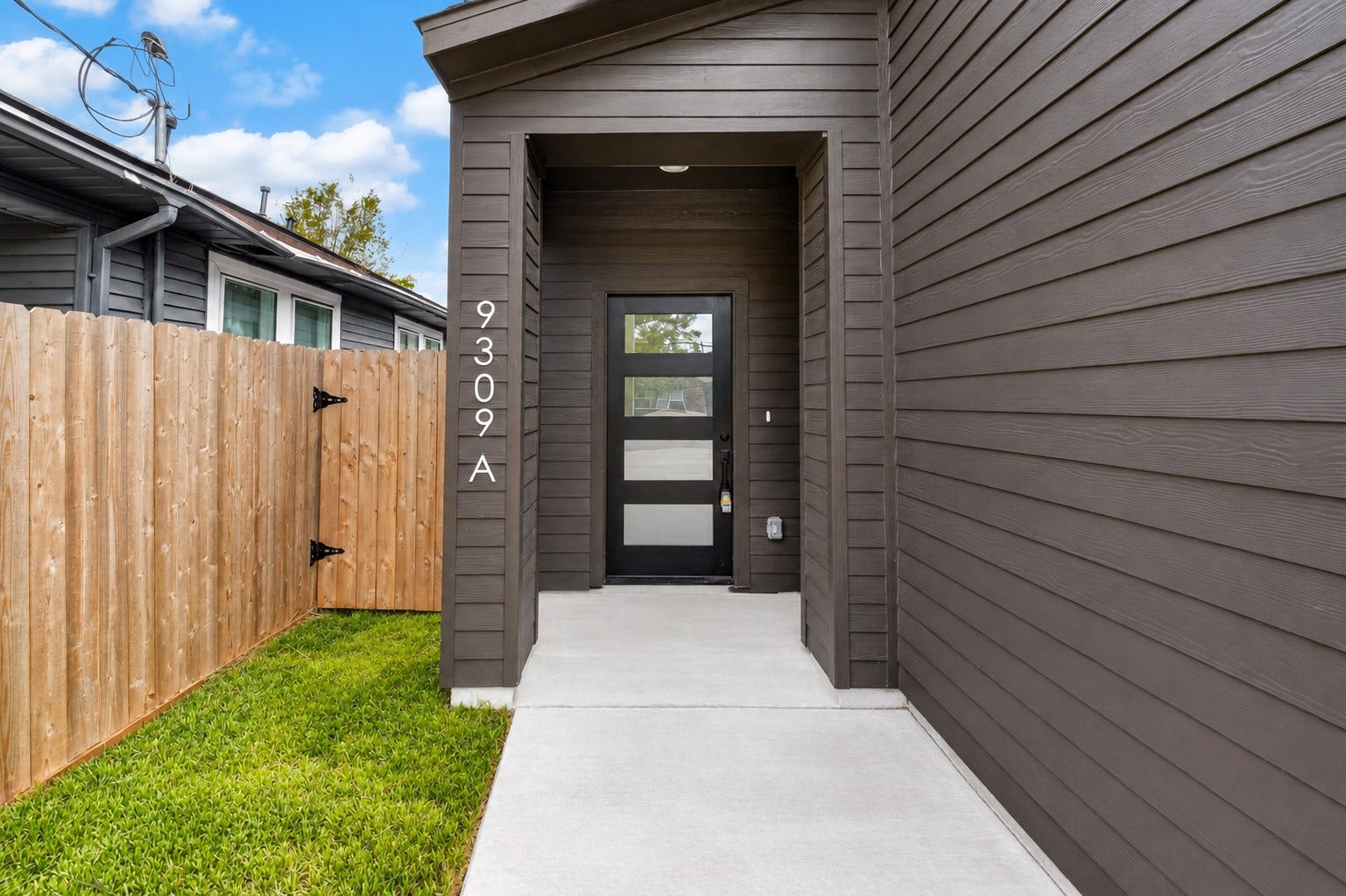 9309 Caddo Road, #A/B, Houston, TX 77078 Welcome to Unit A! Step up to a private, covered entrance featuring crisp modern siding and a contemporary glass-paneled front door that invites warm, natural light in while setting a sophisticated tone right from the start.