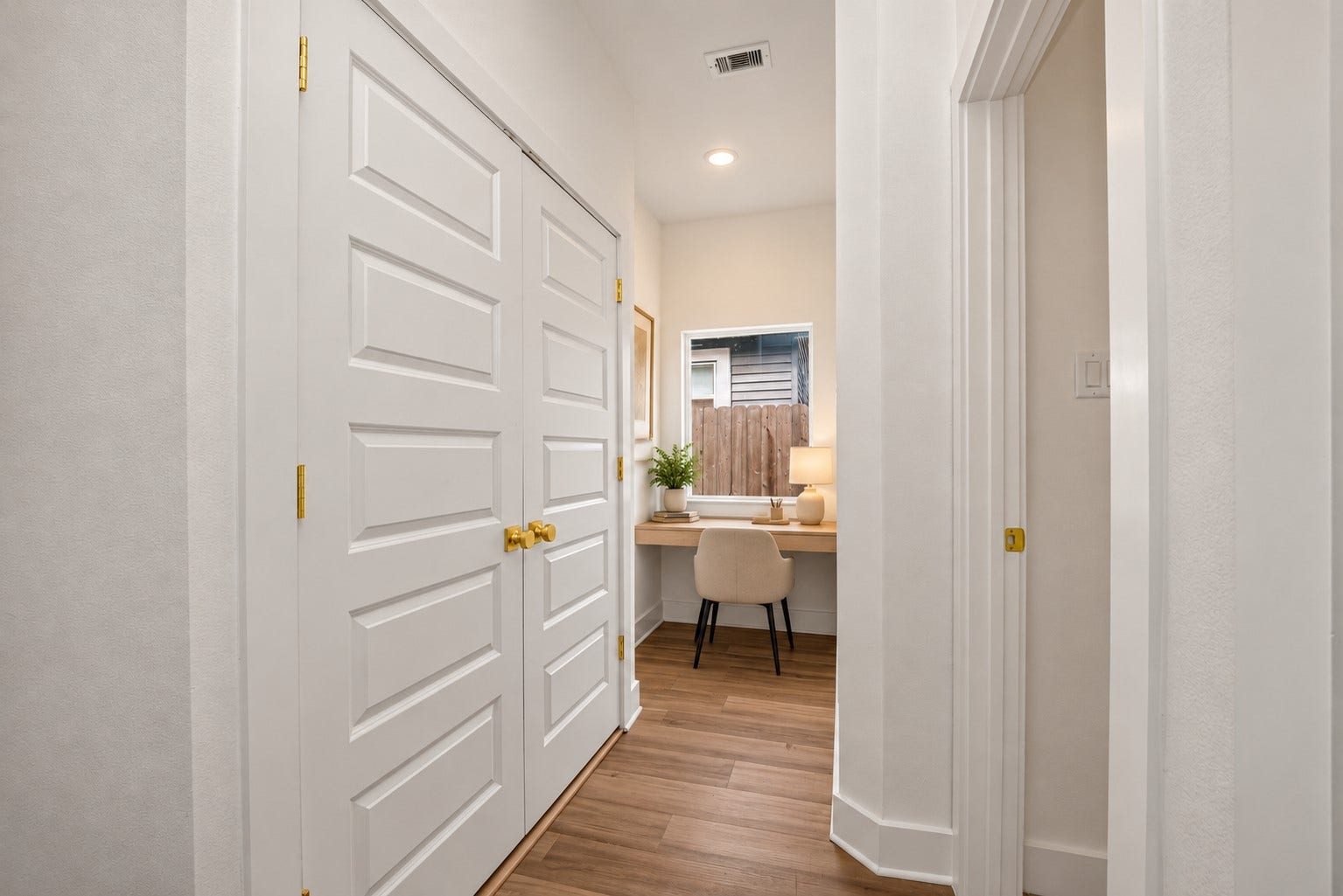 9309 Caddo Road, #A/B, Houston, TX 77078 Digitally staged. Versatile hallway nook with natural light from the window, ideal for a compact home office or study area.