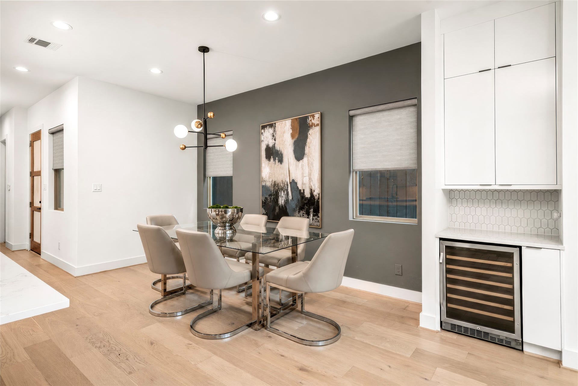 2410 Elmen Street, Houston, TX 77019 Dining Room with accent painted wall and designer light fixture and recessed lighting. Two windows bringing in natural light. Custom shades! Virtually rendered.