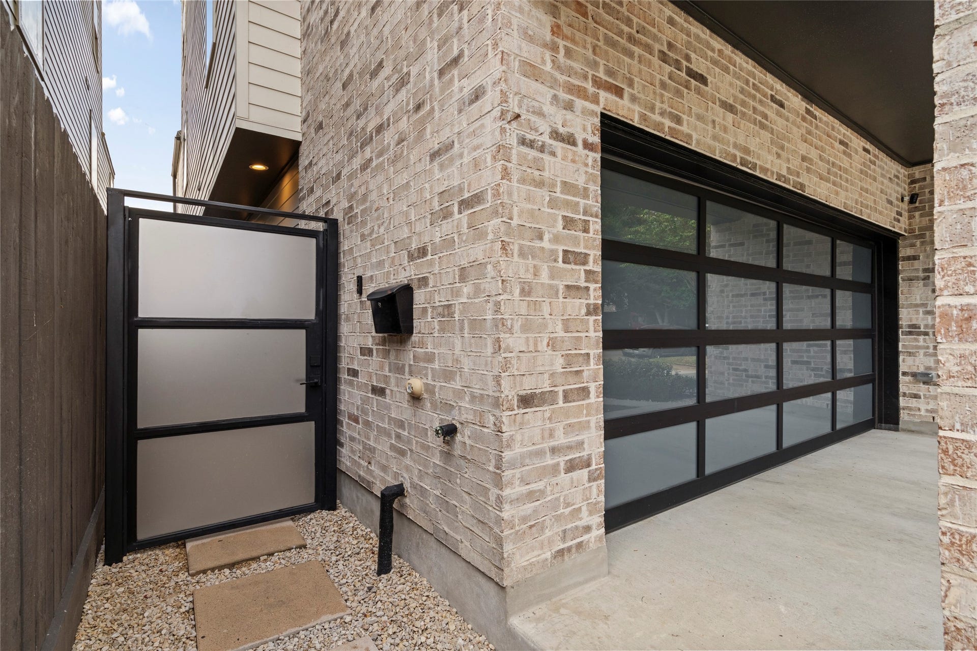 2410 Elmen Street, Houston, TX 77019 Privacy iron pedestrian gate and 16 ft. garage door with glass. Sellers have added tint to the windows.