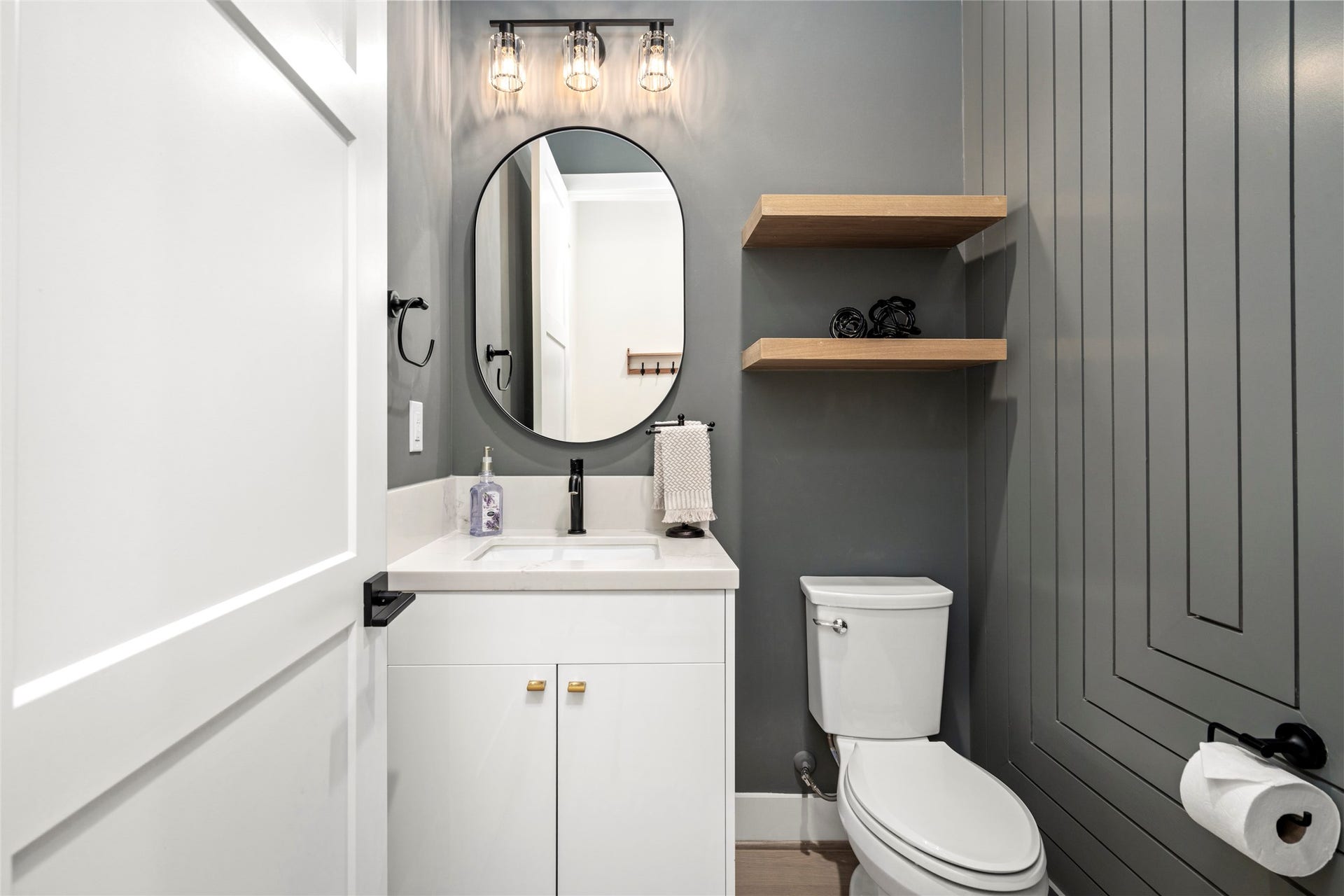 2410 Elmen Street, Houston, TX 77019 Half Bath/Powder Room has custom designer millwork, paint, lighting and fixtures. Located directly as you come in from the garage.
