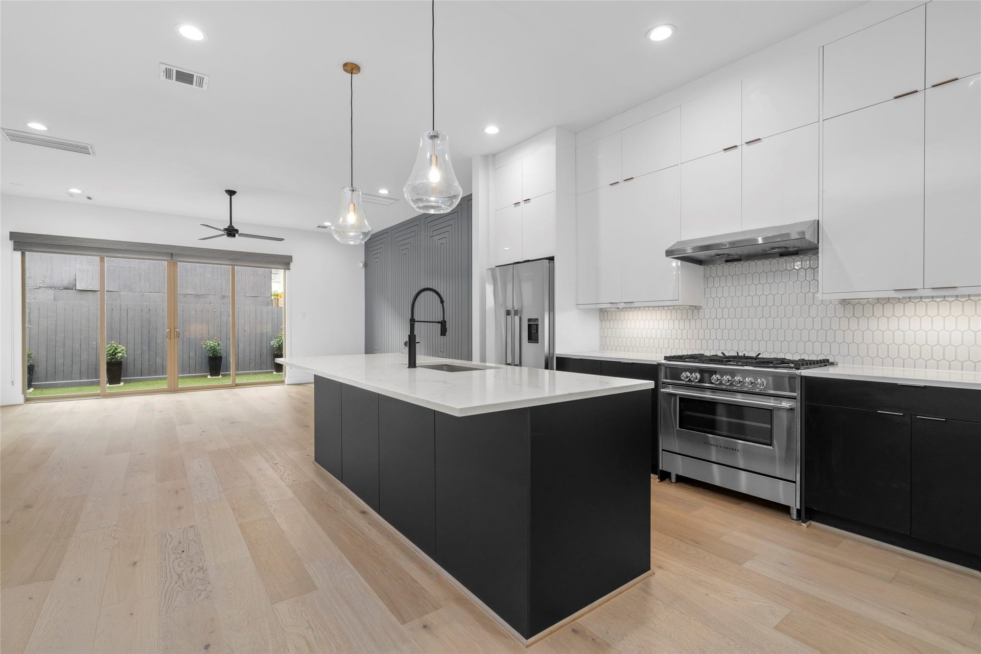 2410 Elmen Street, Houston, TX 77019 Light and bright with recessed lighting, pendants over the island, stainless steel under mount, single bowl sink. Easily seat four at the breakfast bar.
