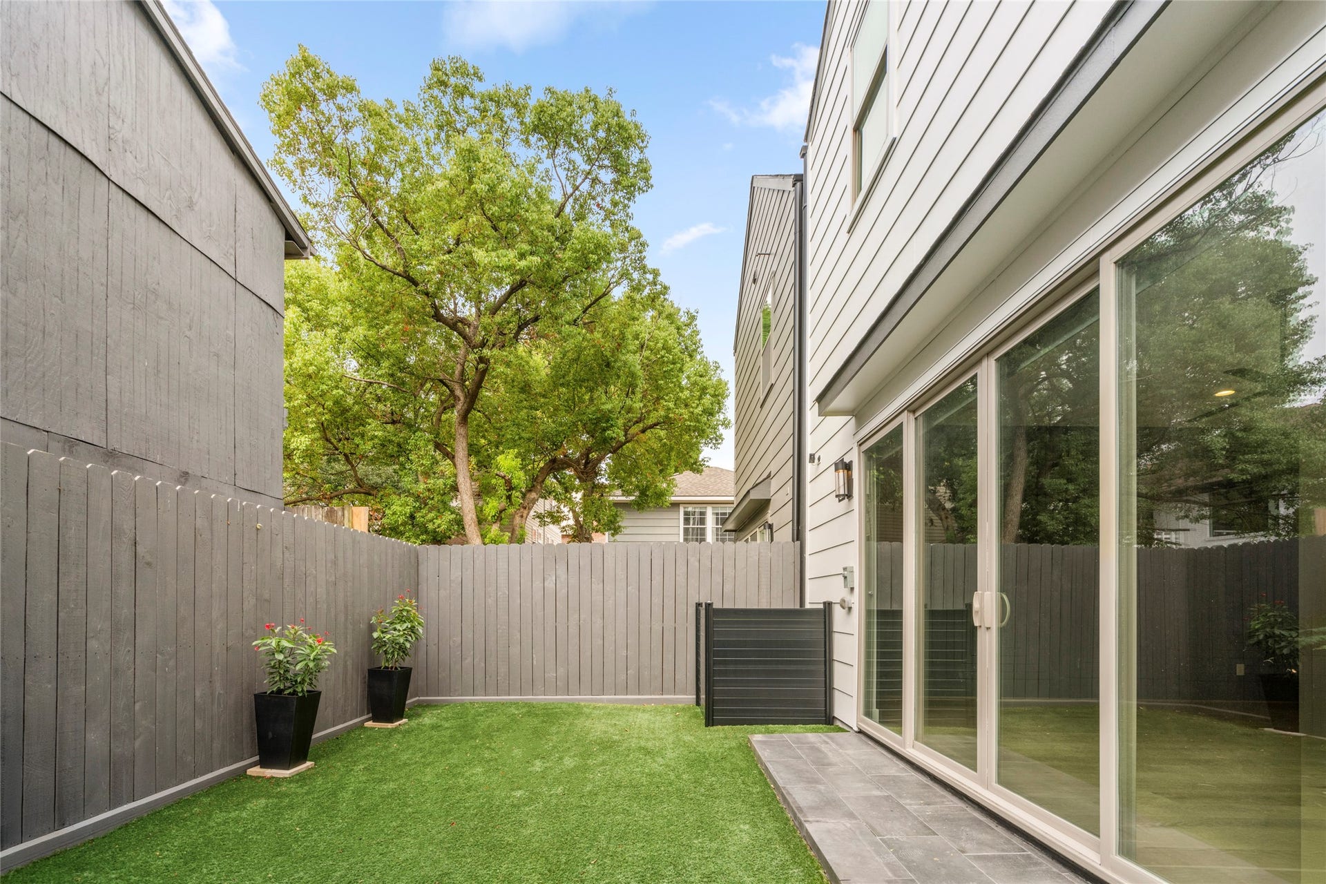 2410 Elmen Street, Houston, TX 77019 Turfed backyard is fully fenced with AC enclosure. Porch just off the living room for easy grilling.