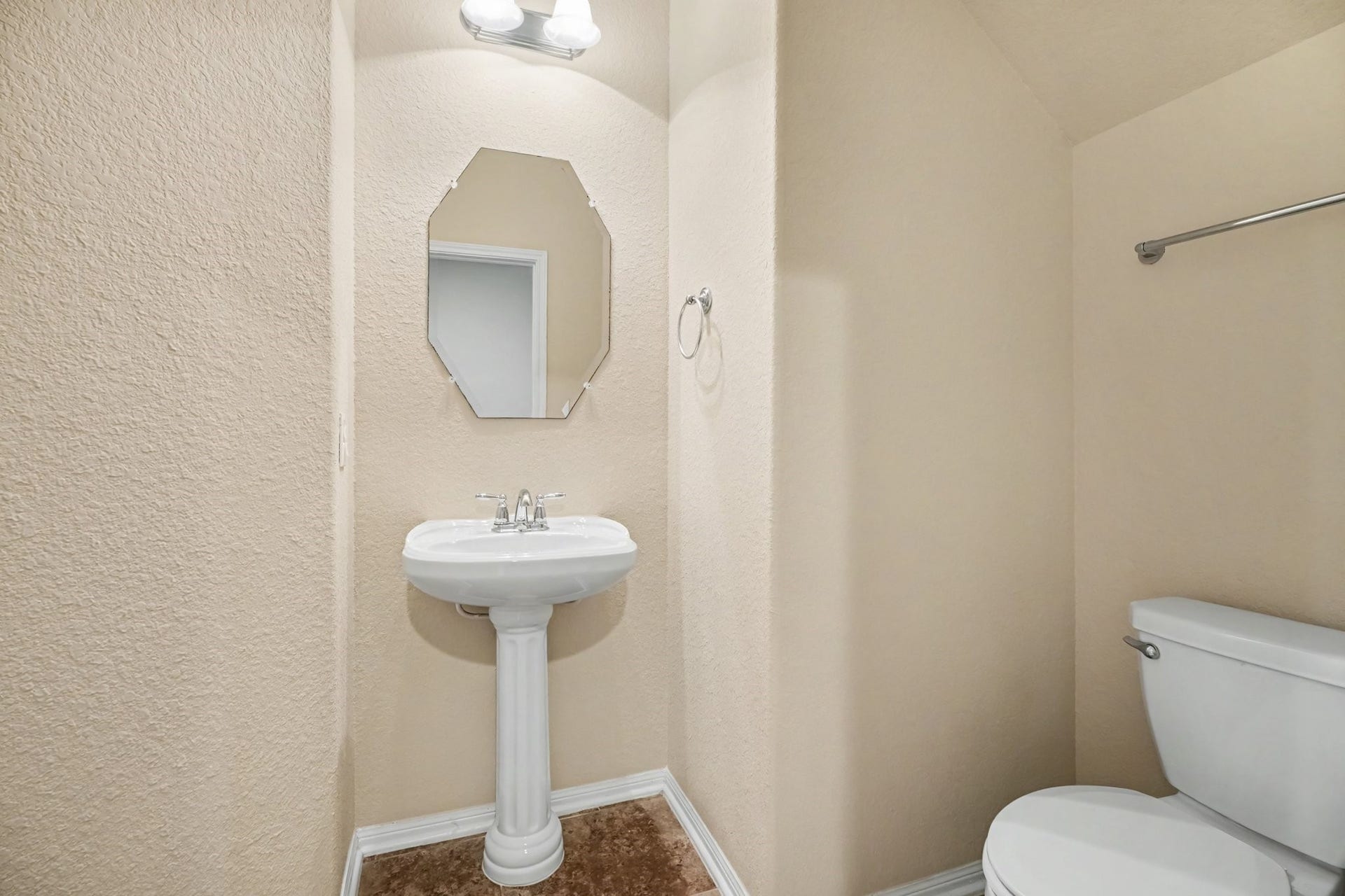 A quaint powder room offers a place for guests to freshen up during a visit.