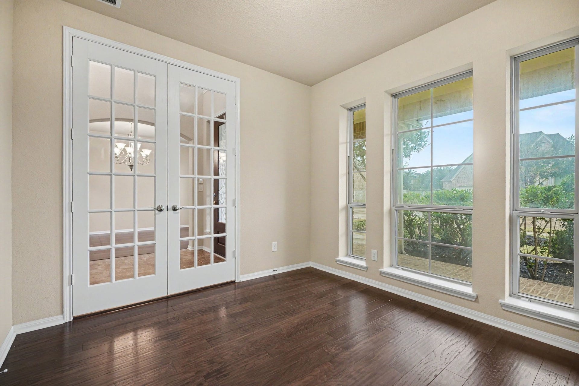 Tucked behind double French doors you will find this private home office with tons of natural light!