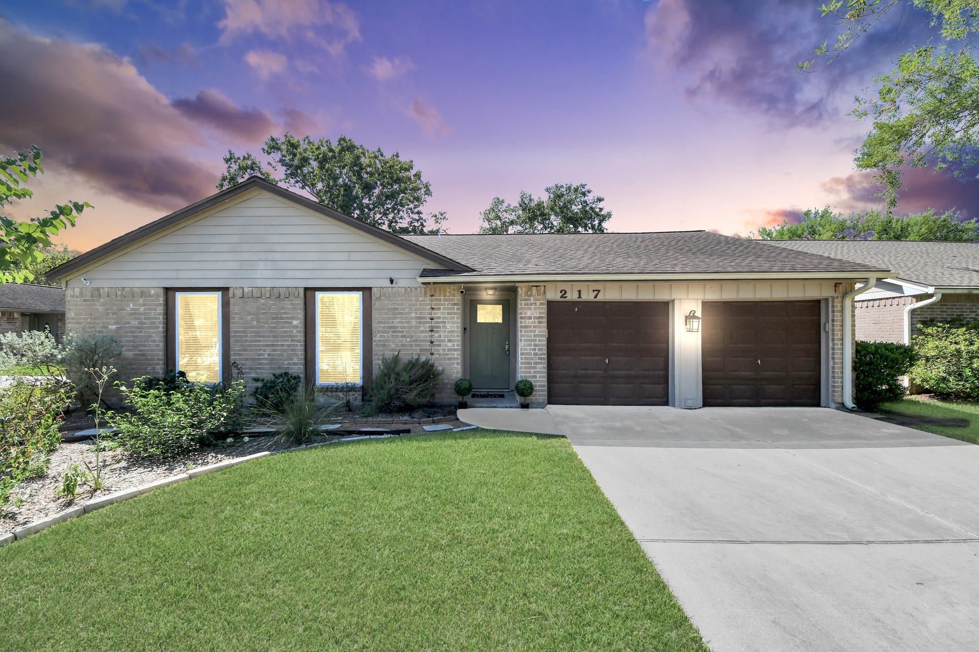 217 Greenshire Drive, League City, TX 77573 A welcoming first look at the home with a wide driveway, two-car garage and mature landscaping