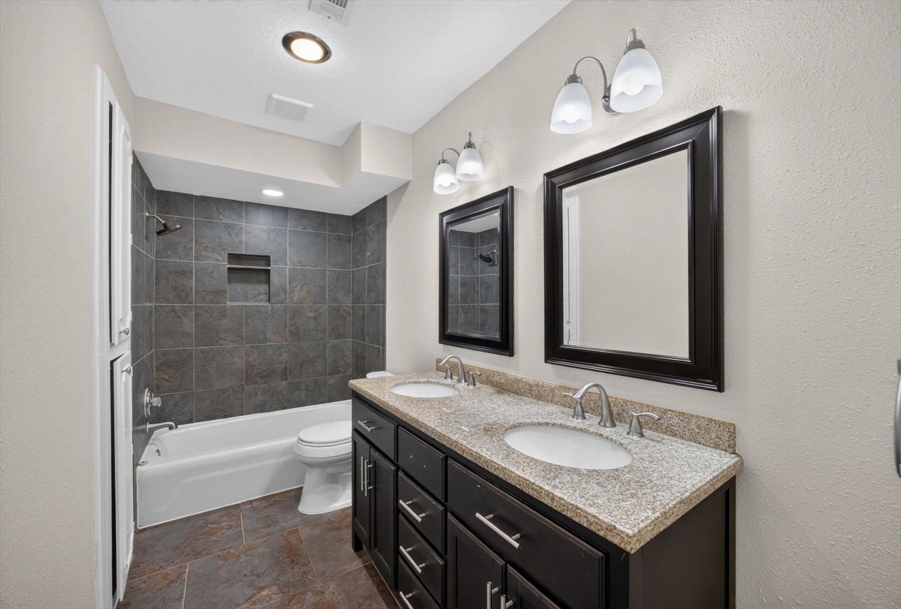 Secondary bathroom has double sinks and a tub/shower combo.