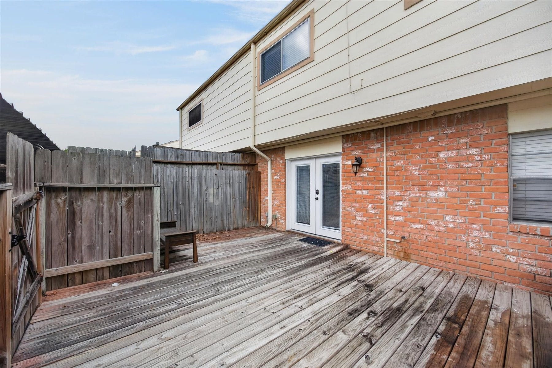 Wood decking with french doors as the entryway.