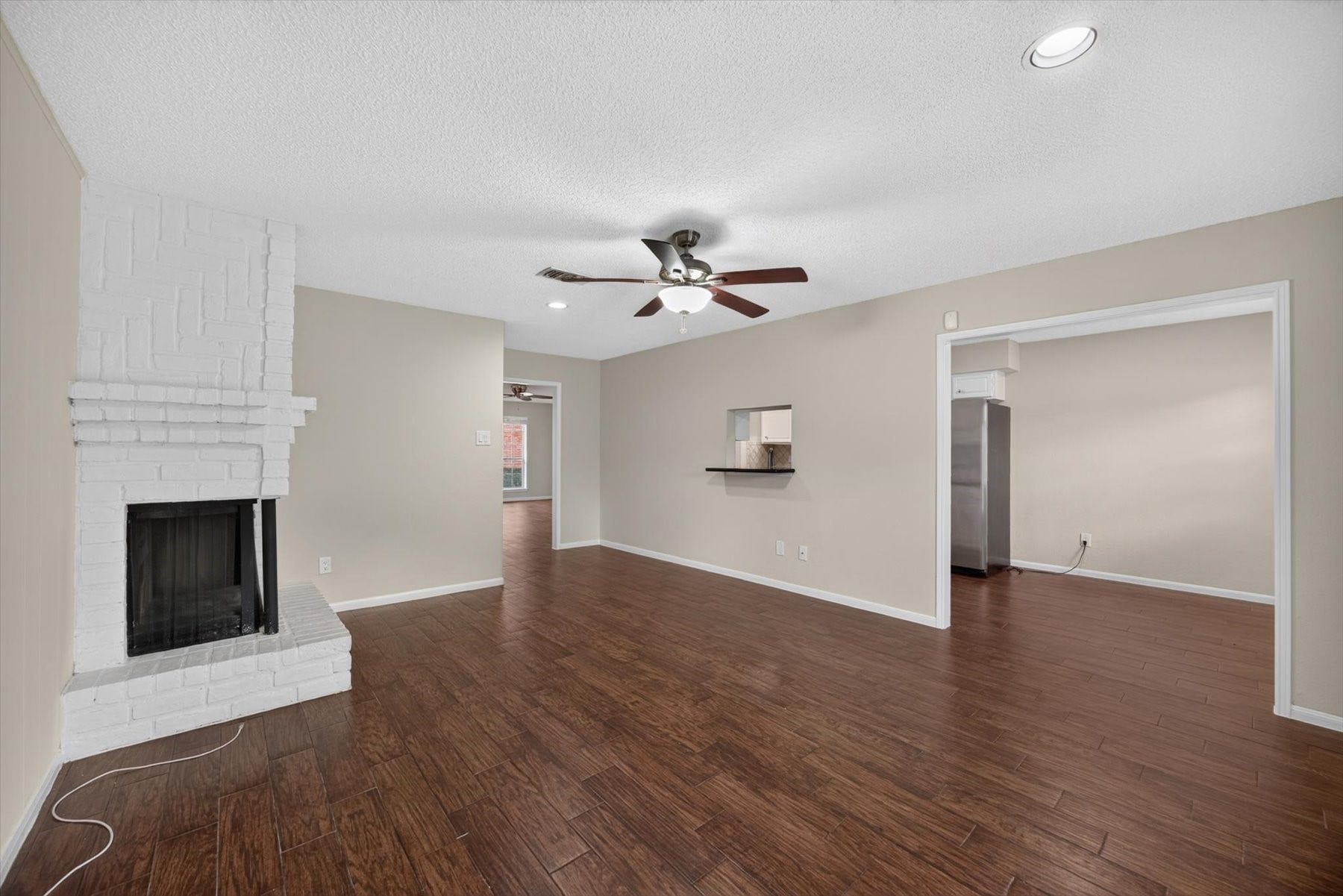 Another look at the second space downstairs. This space works well as a formal dining with a pass through area from the kitchen. Plenty of space to have a formal dining and a sitting area by the fireplace. Great for entertaining.