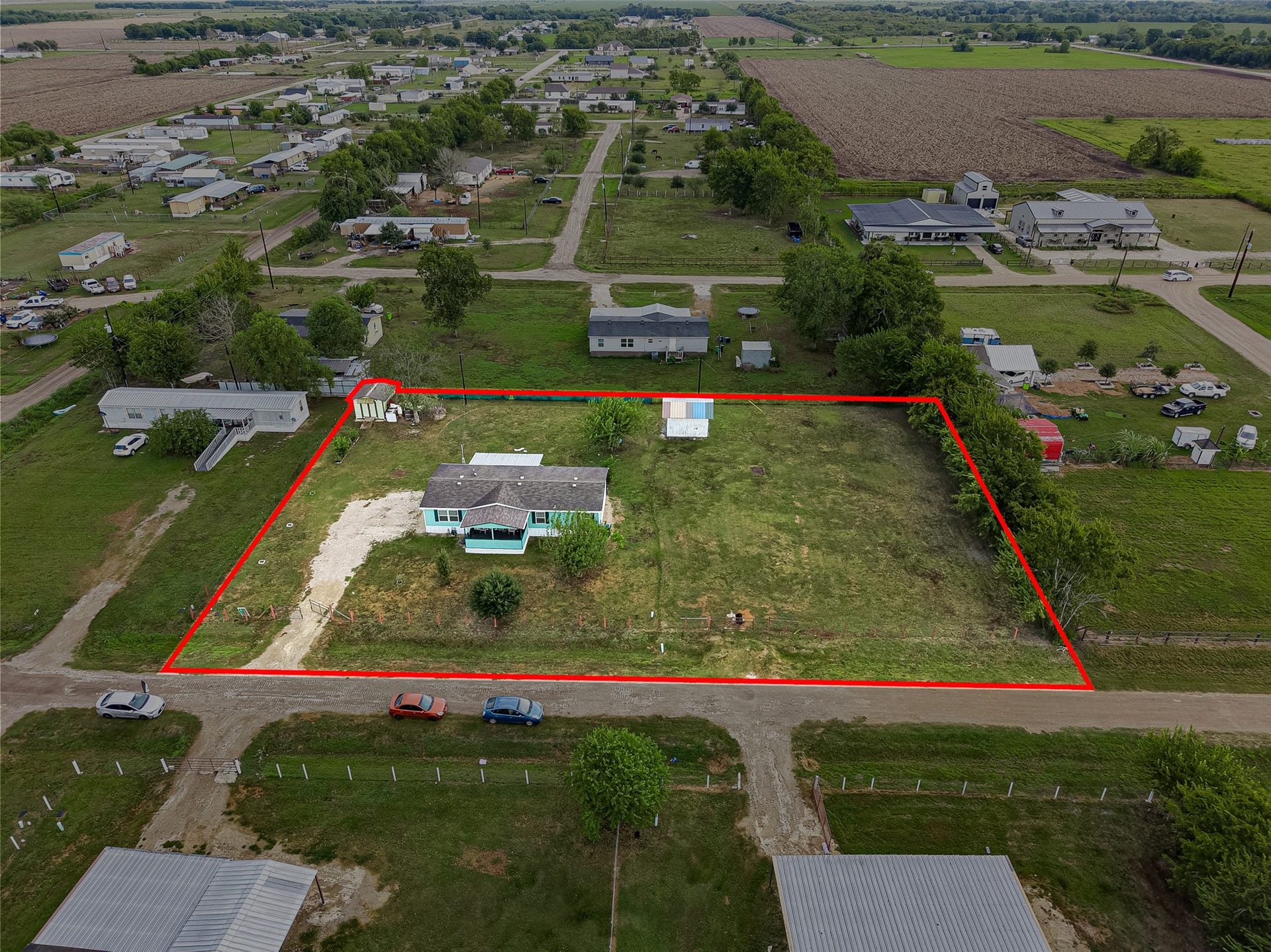 Aerial perspective highlighting the property's lot lines and spacious grounds - 1 ACRE with endless possibilites! Utilities available and ready.
