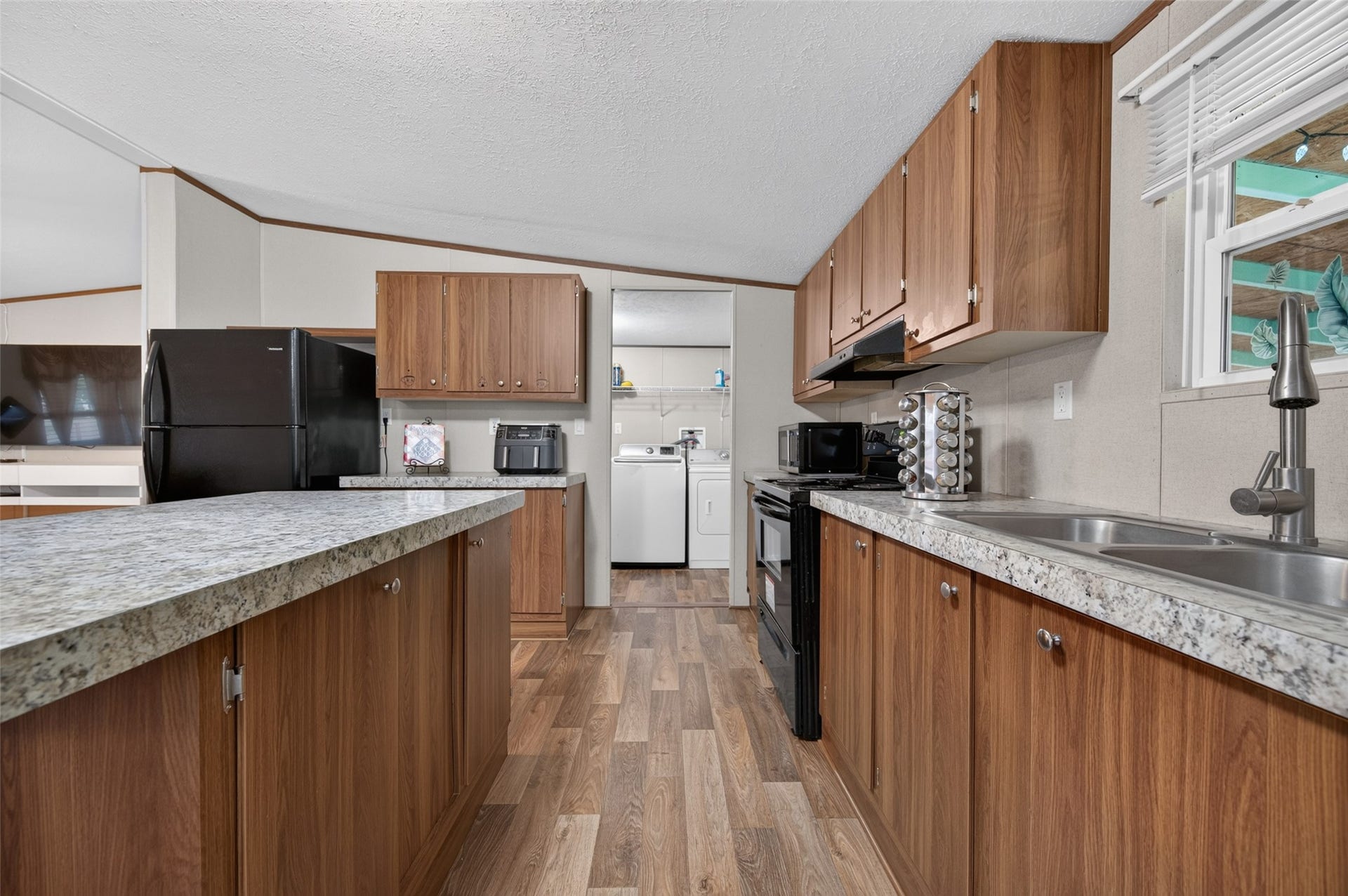 Kitchen sink area with convenient access to the adjoining laundry room