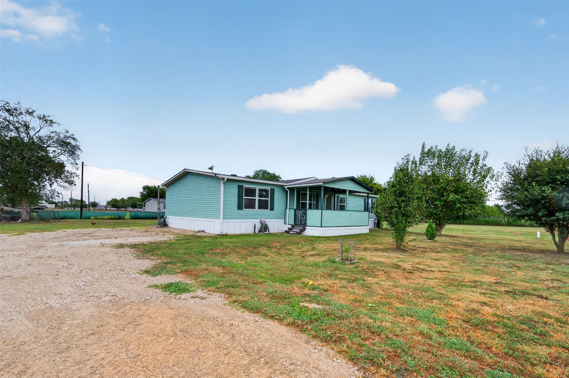 Long driveway leads to ample parking and the front entry