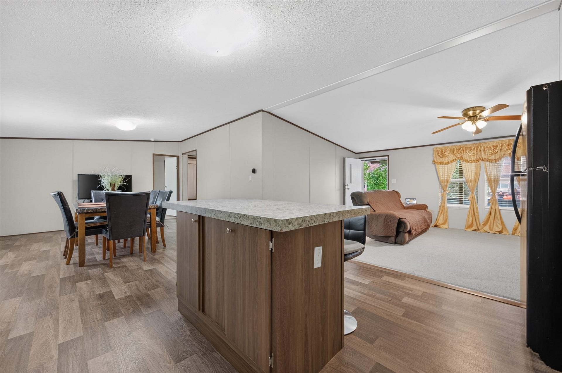 Open-concept flow from the kitchen island to the dining and living spaces