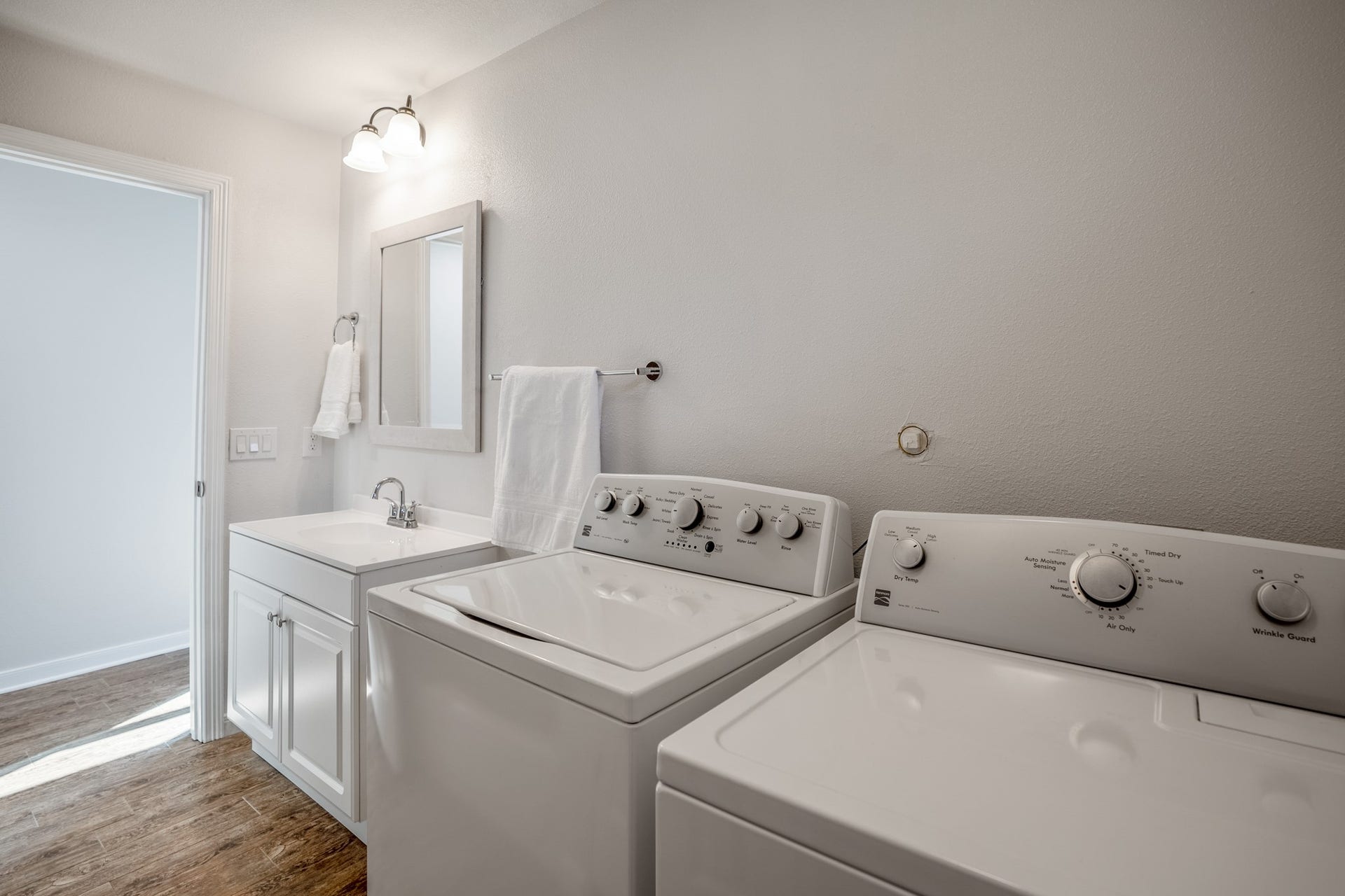 306 Foster Street, Tomball, TX 77375 Looking back toward the vanity from the laundry area, you can see how the space accommodates a full-size washer & dryer without sacrificing bathroom functionality. Both appliances are included with the lease, making move-in that much easier!