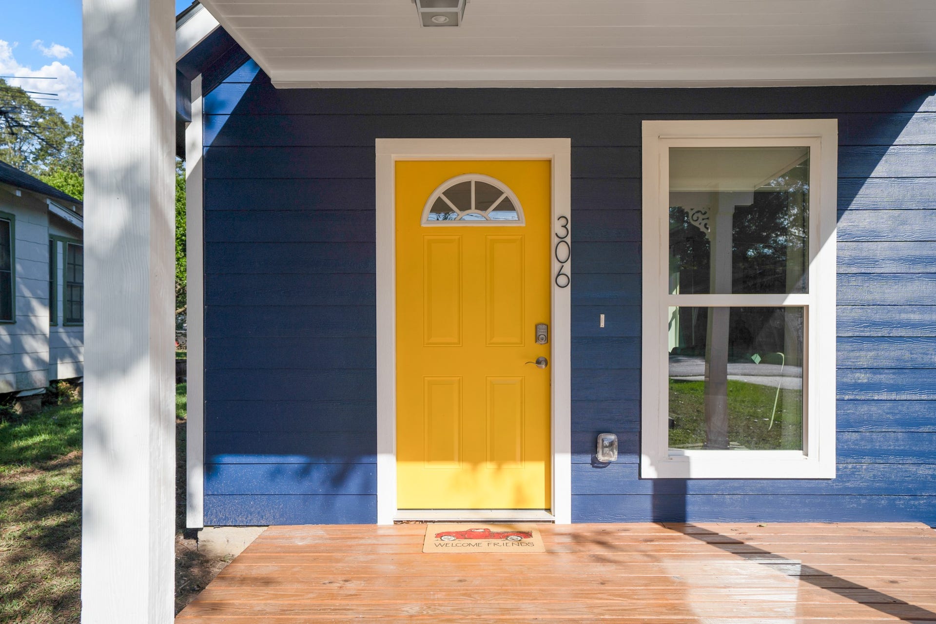 306 Foster Street, Tomball, TX 77375 That cheerful yellow front door makes quite the first impression! Contrasting navy blue siding, crisp white trim & a covered front porch create an inviting entrance, with room to add a couple of chairs & enjoy your morning coffee.
