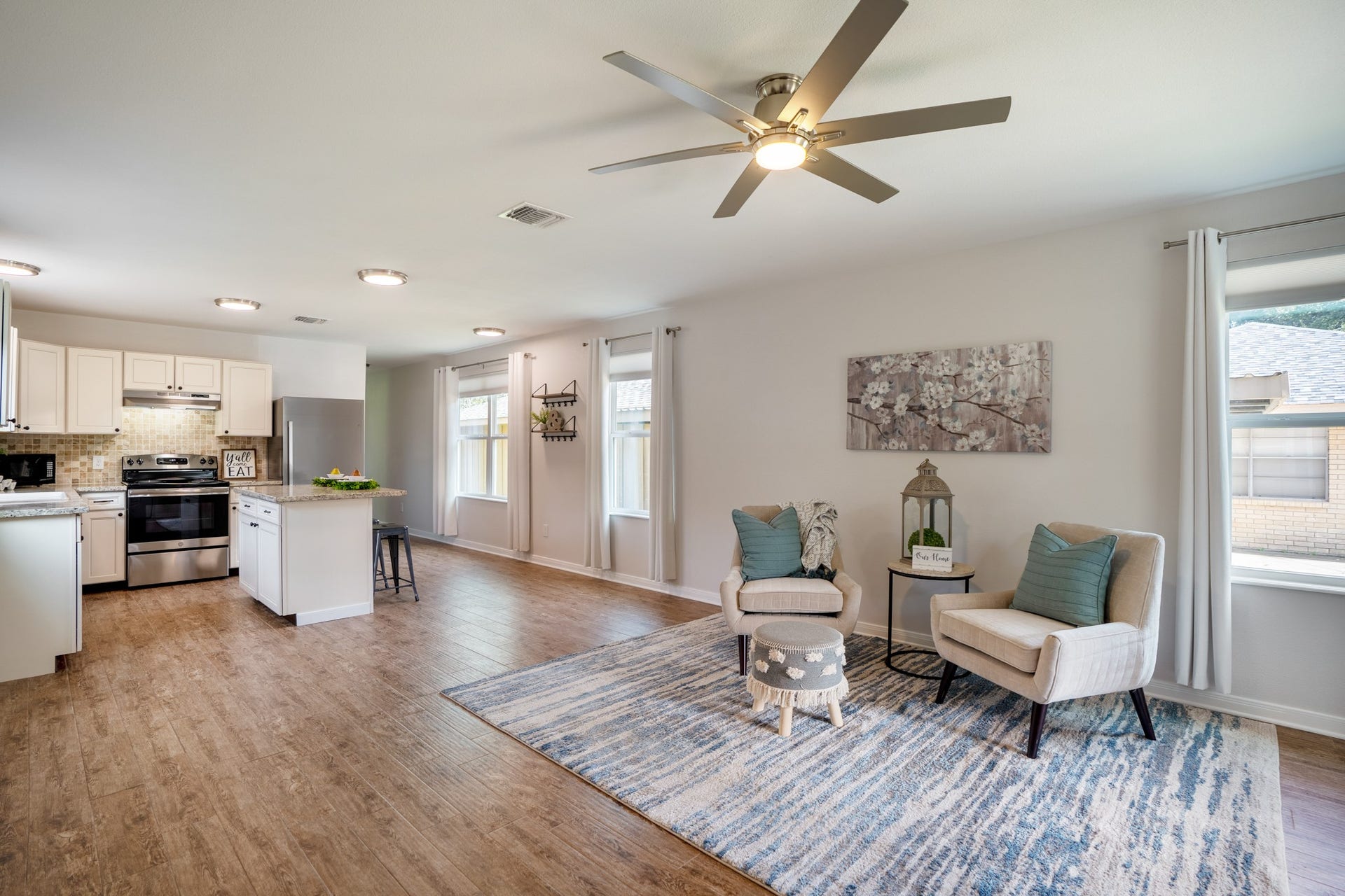 306 Foster Street, Tomball, TX 77375 Moving farther into the living room, multiple windows bring in plenty of natural light, while neutral walls & a modern ceiling fan complement the open layout. The kitchen & breakfast bar are just steps away, making this an inviting space for relaxing or entertaining.