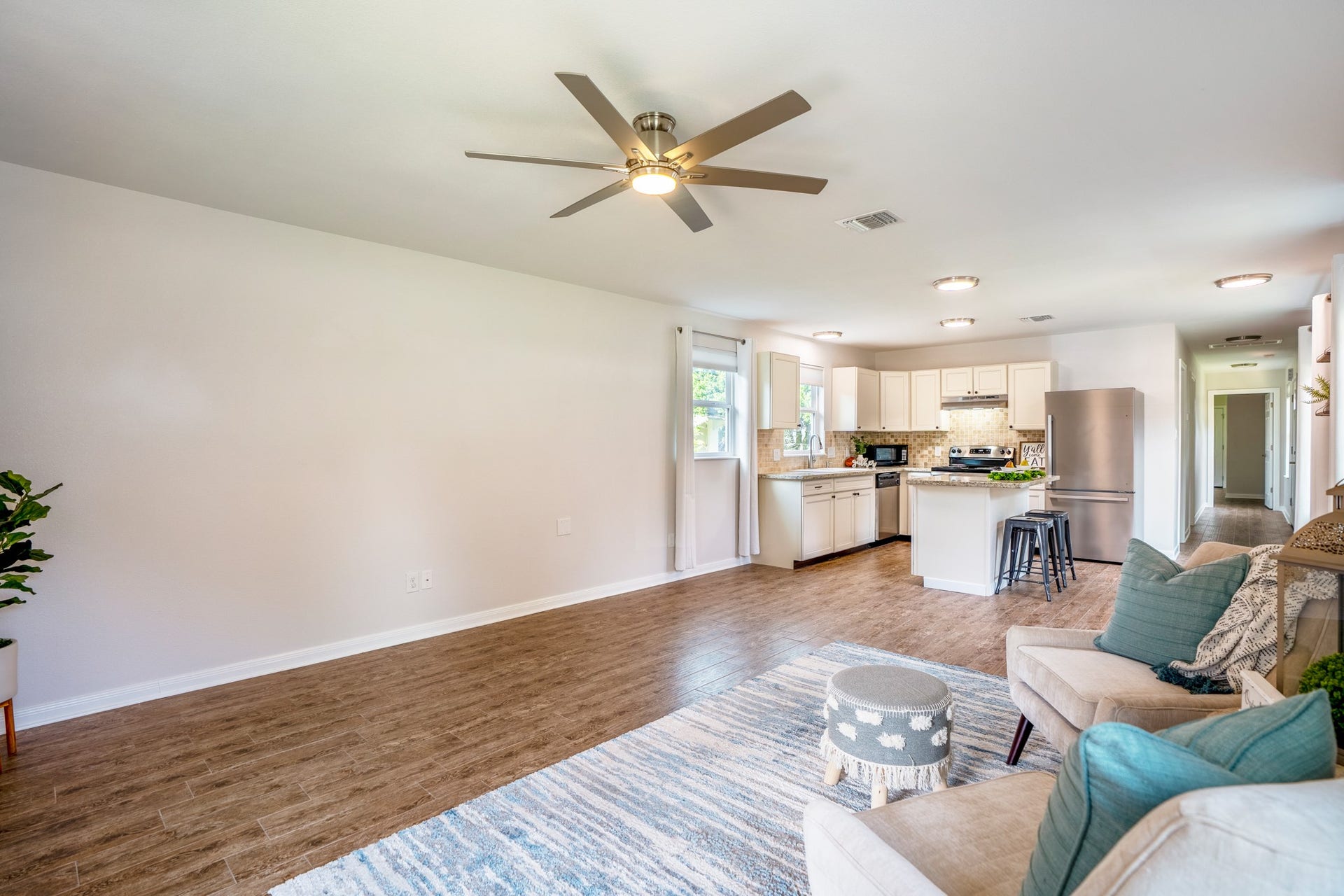 306 Foster Street, Tomball, TX 77375 Another look at the spacious living room reveals plenty of room to arrange your furniture. The open kitchen and breakfast bar sit just beyond, while the hallway to the right leads to the bedrooms & bathroom.
