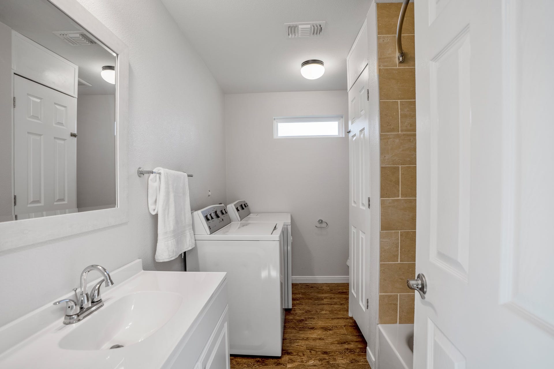 306 Foster Street, Tomball, TX 77375 The first door on the left of the hallway opens to the full secondary bathroom, which also houses the laundry area. A shower/tub combination with neutral tile, white vanity & built-in linen closet offer plenty of functionality. The washer & dryer are included with the lease!