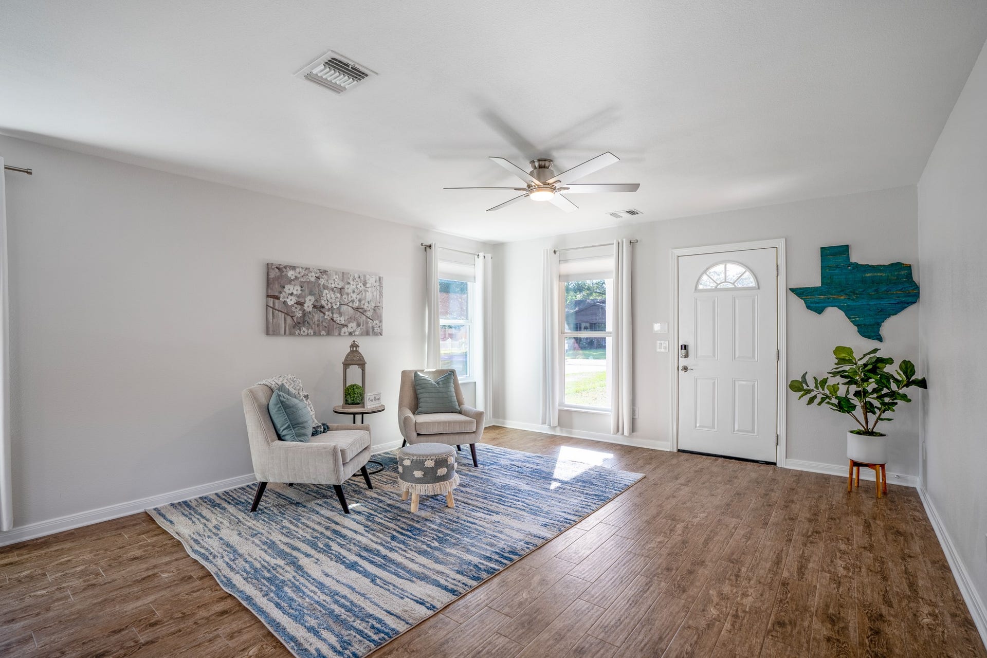 306 Foster Street, Tomball, TX 77375 Looking back toward the living room from the kitchen, large windows fill the space with gorgeous natural light! When its time for a cozy movie night, simply lower the blinds & draw the curtains to settle in and relax.