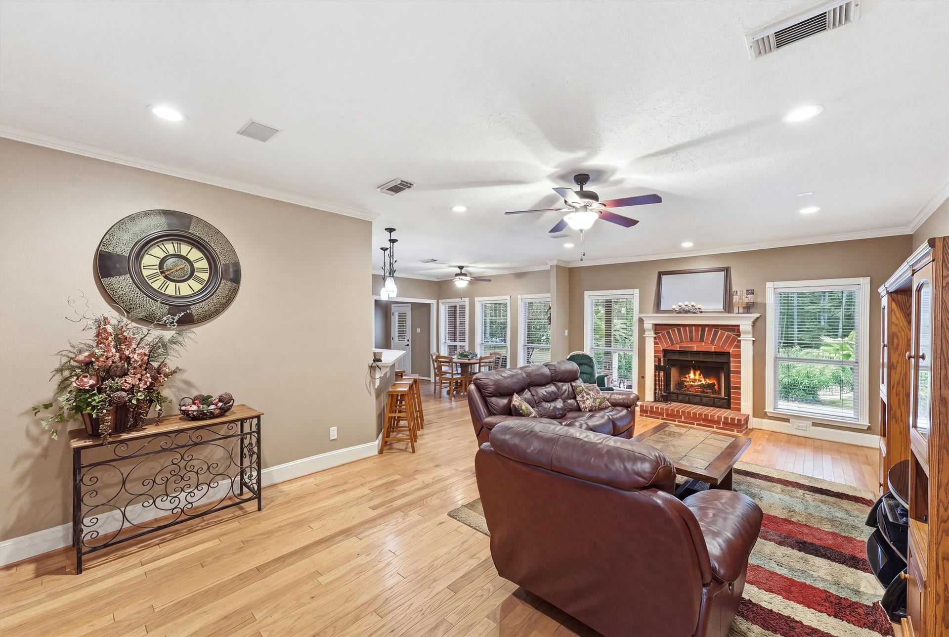 Inviting living room featuring windows that fill the space with natural light and a cozy gas fireplace that creates a warm and welcoming atmosphere.