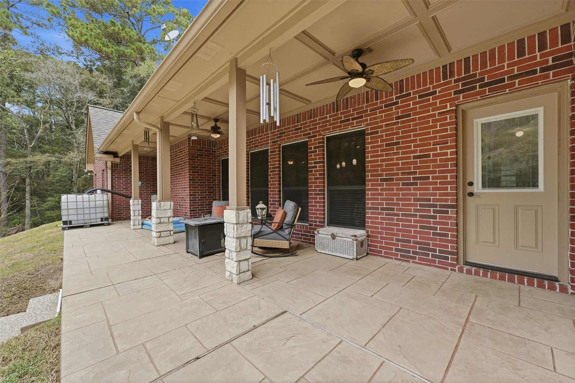 Peaceful covered back porch overlooking beautiful swimming pool and natural surroundings.