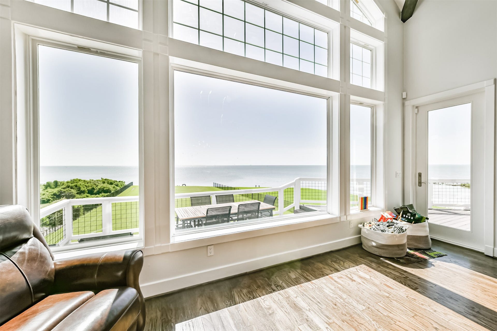 Stunning ocean views through expansive windows flood the living space with natural light, seamlessly blending indoor comfort with outdoor beauty.