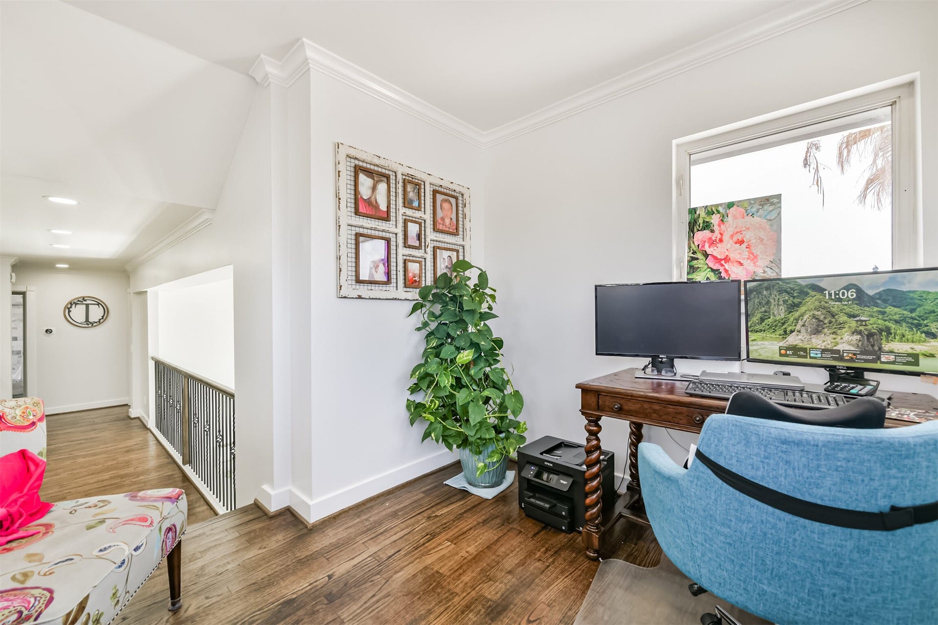 Cozy and inviting space with hardwood floors, a large window providing natural light, and a charming setup ideal for productivity.