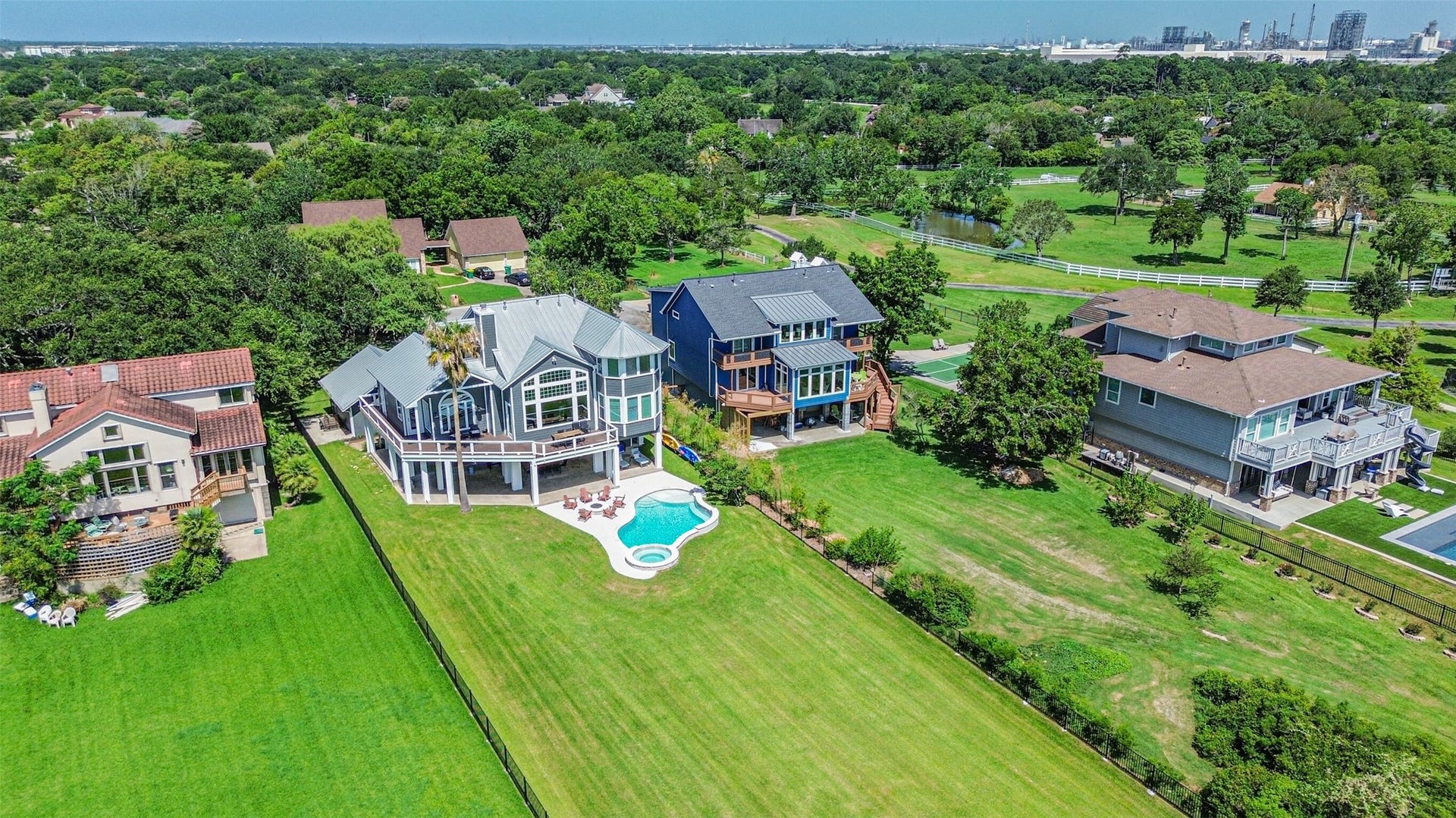 Luxurious waterfront home with a spacious backyard, private pool, and expansive views, nestled in a serene neighborhood.
