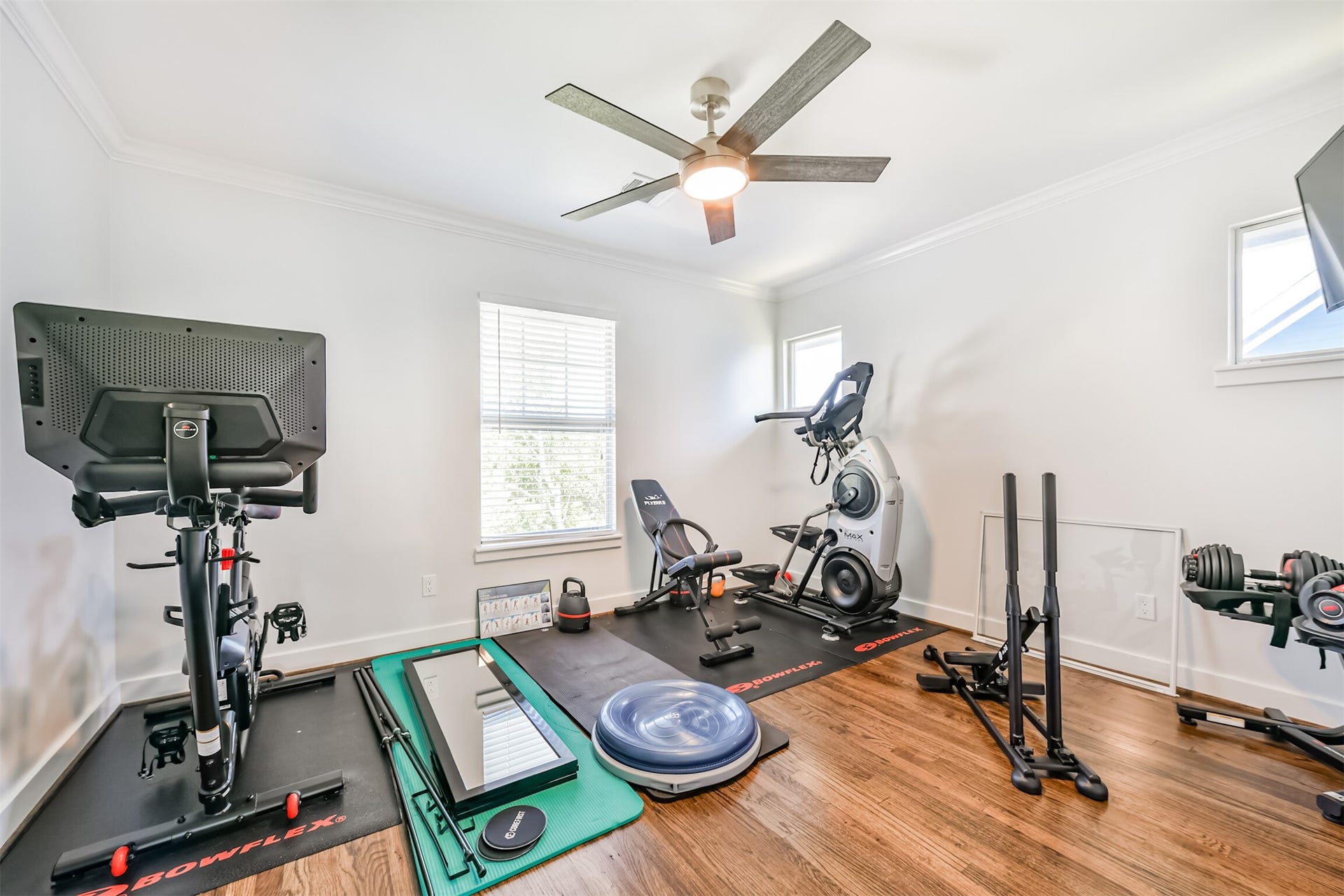 A bright and functional room that can be used as a home gym or office space.