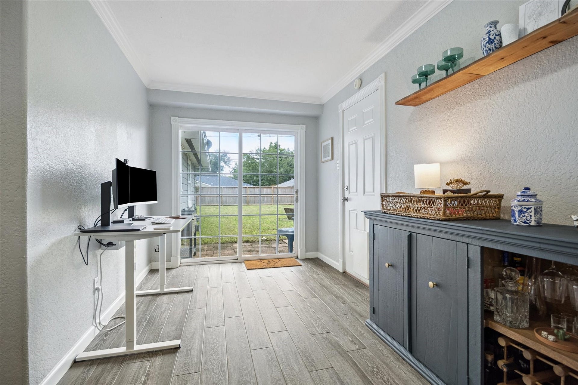 The flex space off the dining area offers a wall of sliding glass doors that open to the backyard. This extra space is great for home office, craft room, work out, or kids play area.